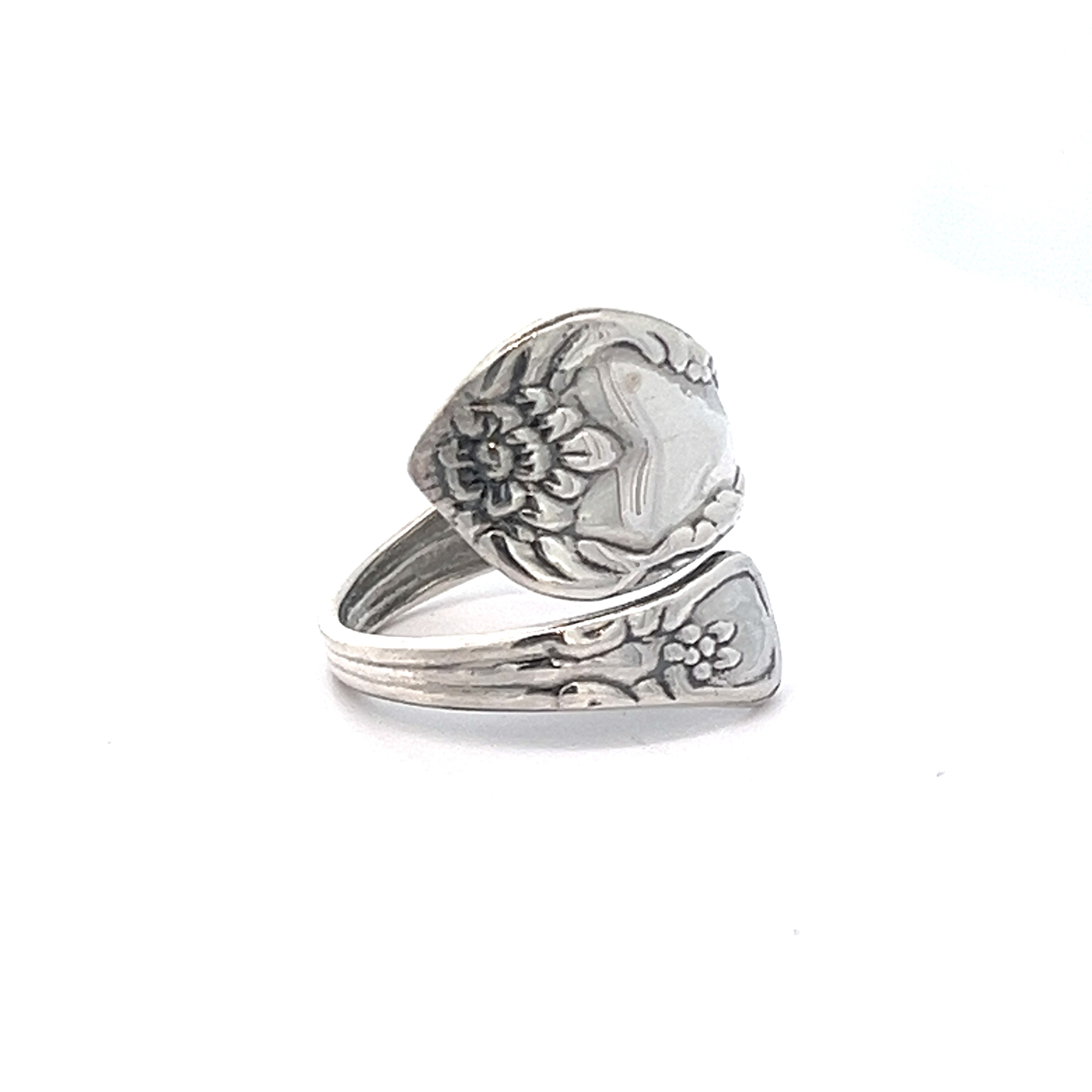 A Timeless Spoon Ring made from .925 Sterling Silver, showcasing intricate floral engravings and a wrap-around design.