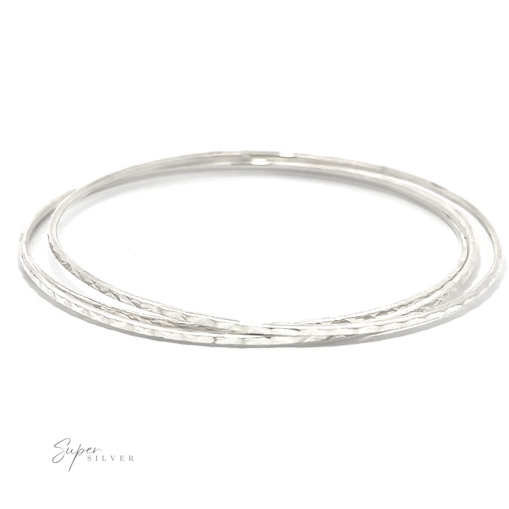 
                  
                    A pair of Sparkling Faceted Bangle Bracelets with a minimal vibe on a white background.
                  
                