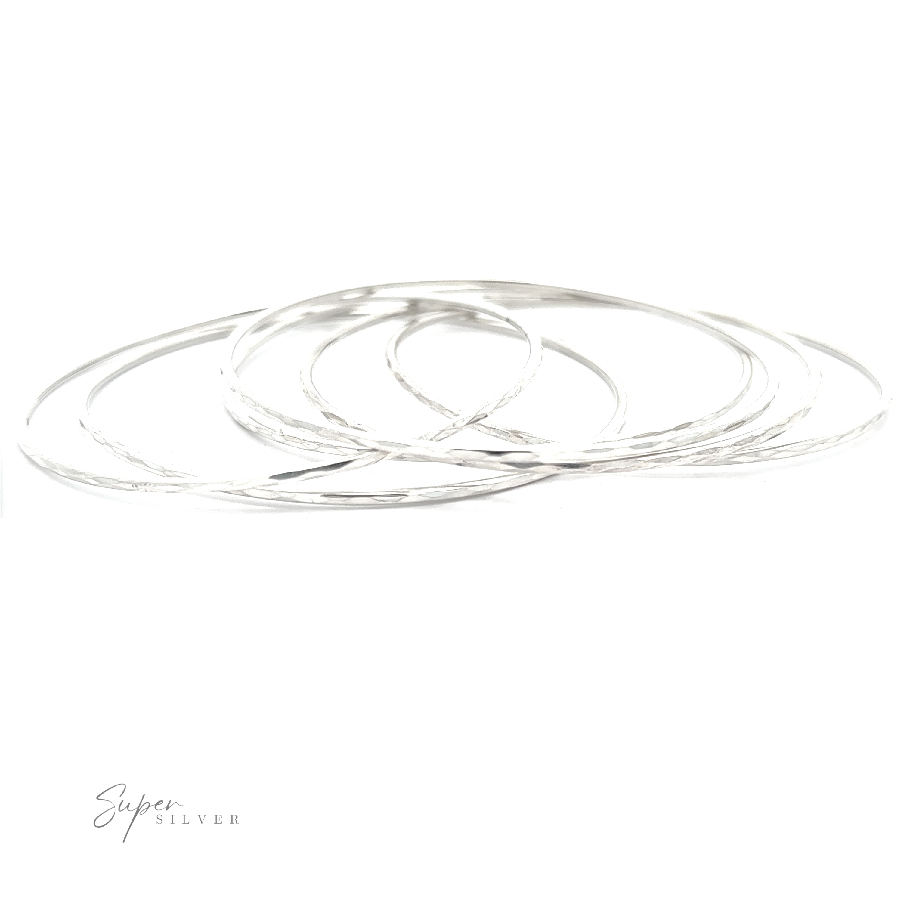 A stack of Elegant Faceted Bangle Bracelets on a white background, sparkling delicately.
