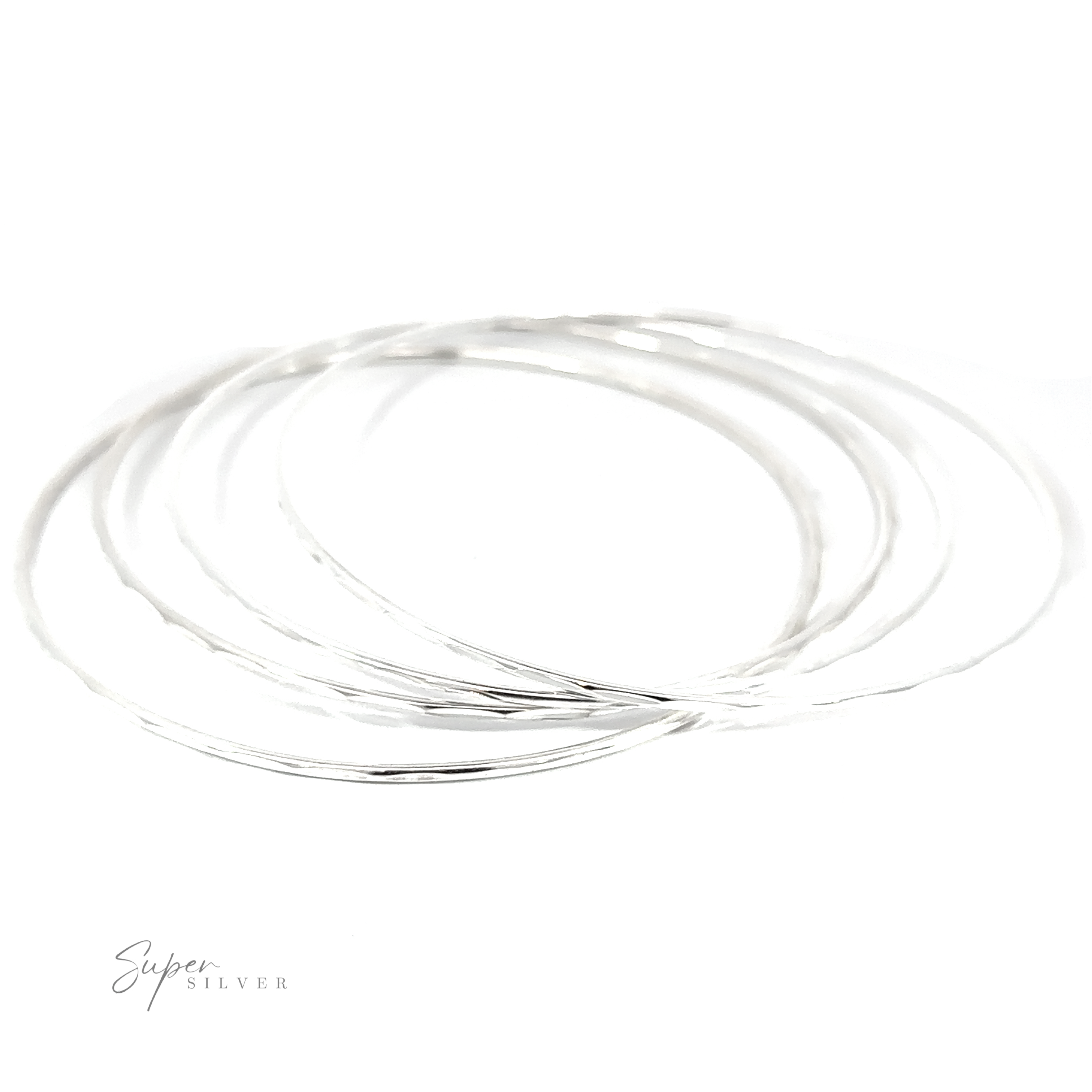 A stack of Dainty Faceted Silver Bangles on a white background.