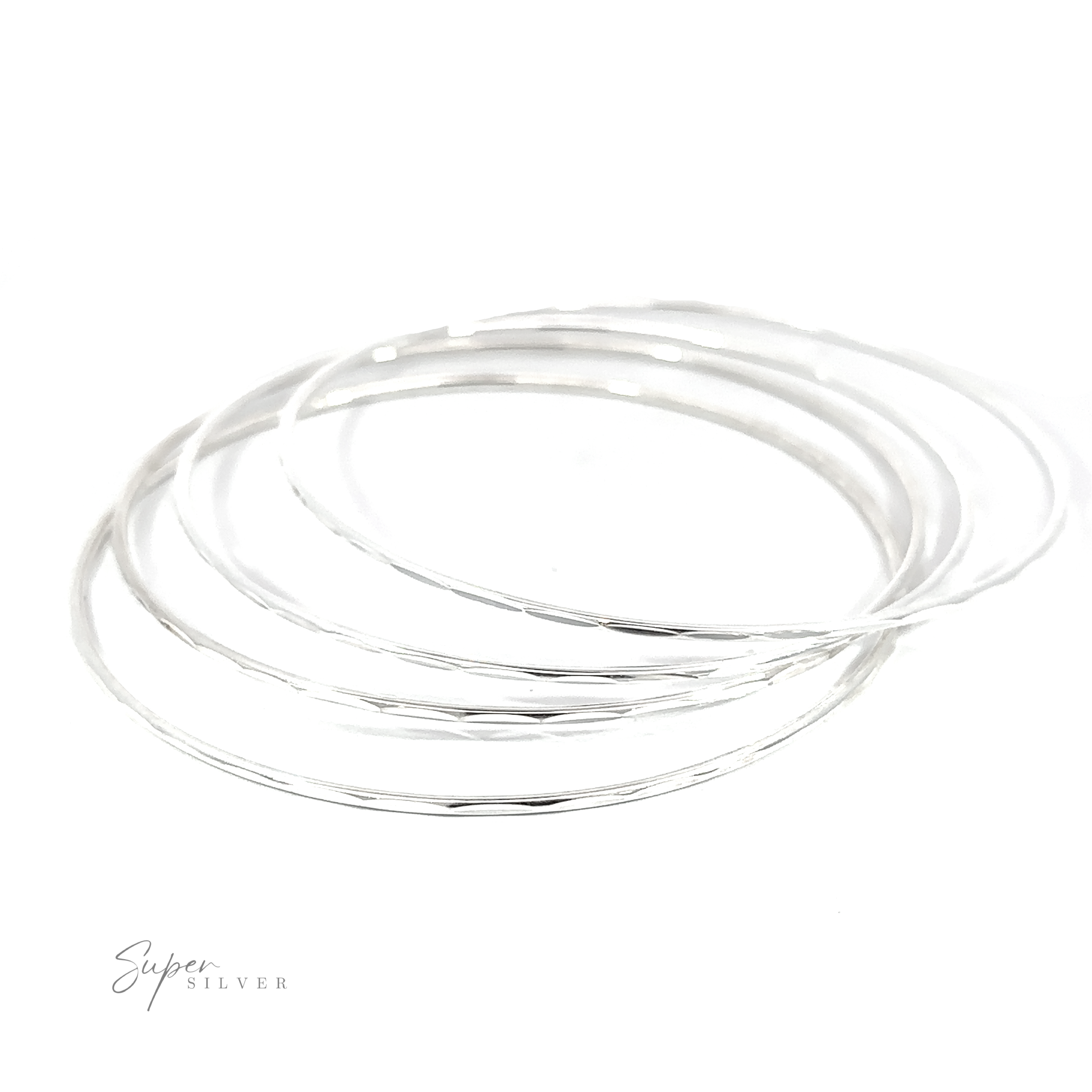 A stack of Dainty Faceted Silver Bangles on a white background.