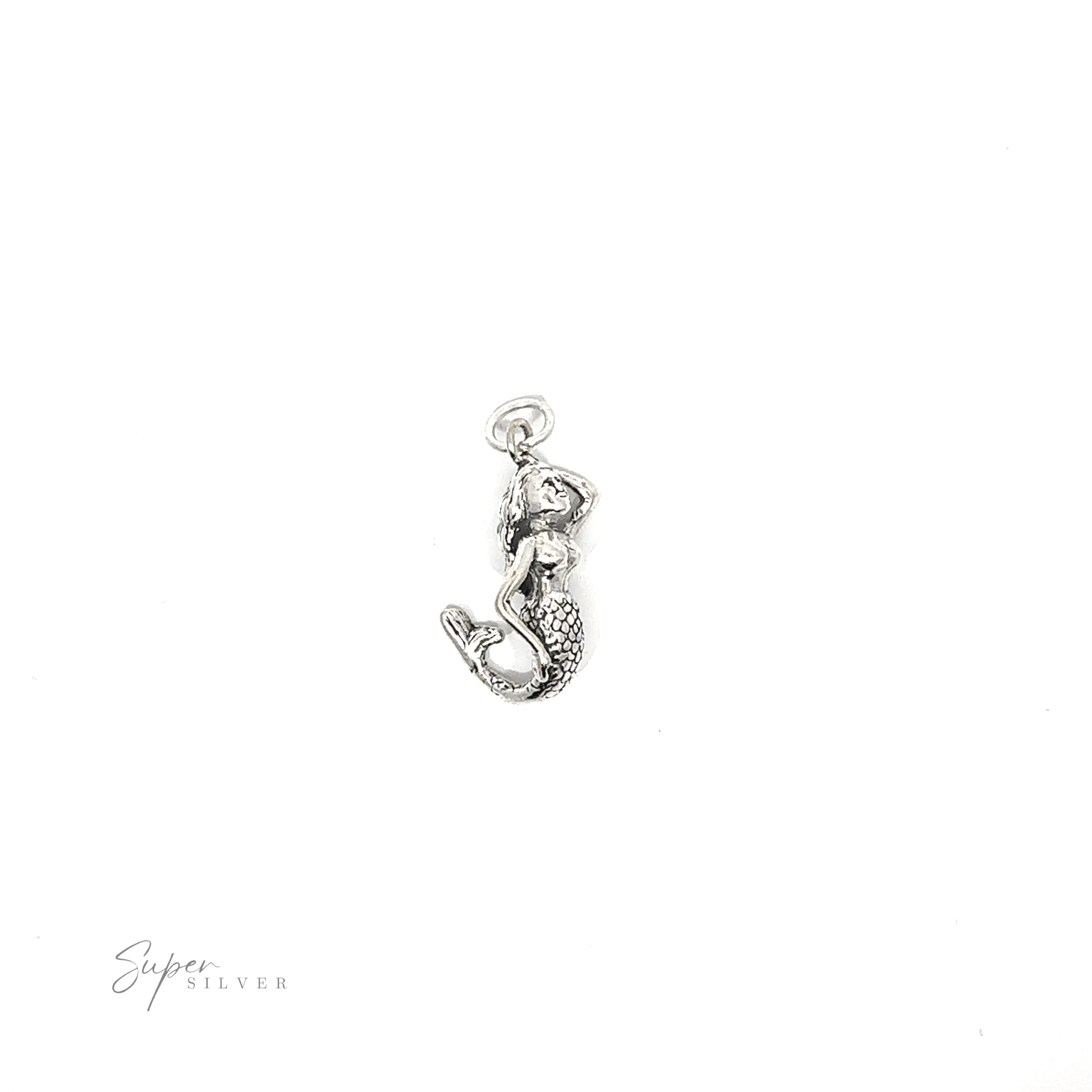 An enchanting small mermaid charm resting on a white background.