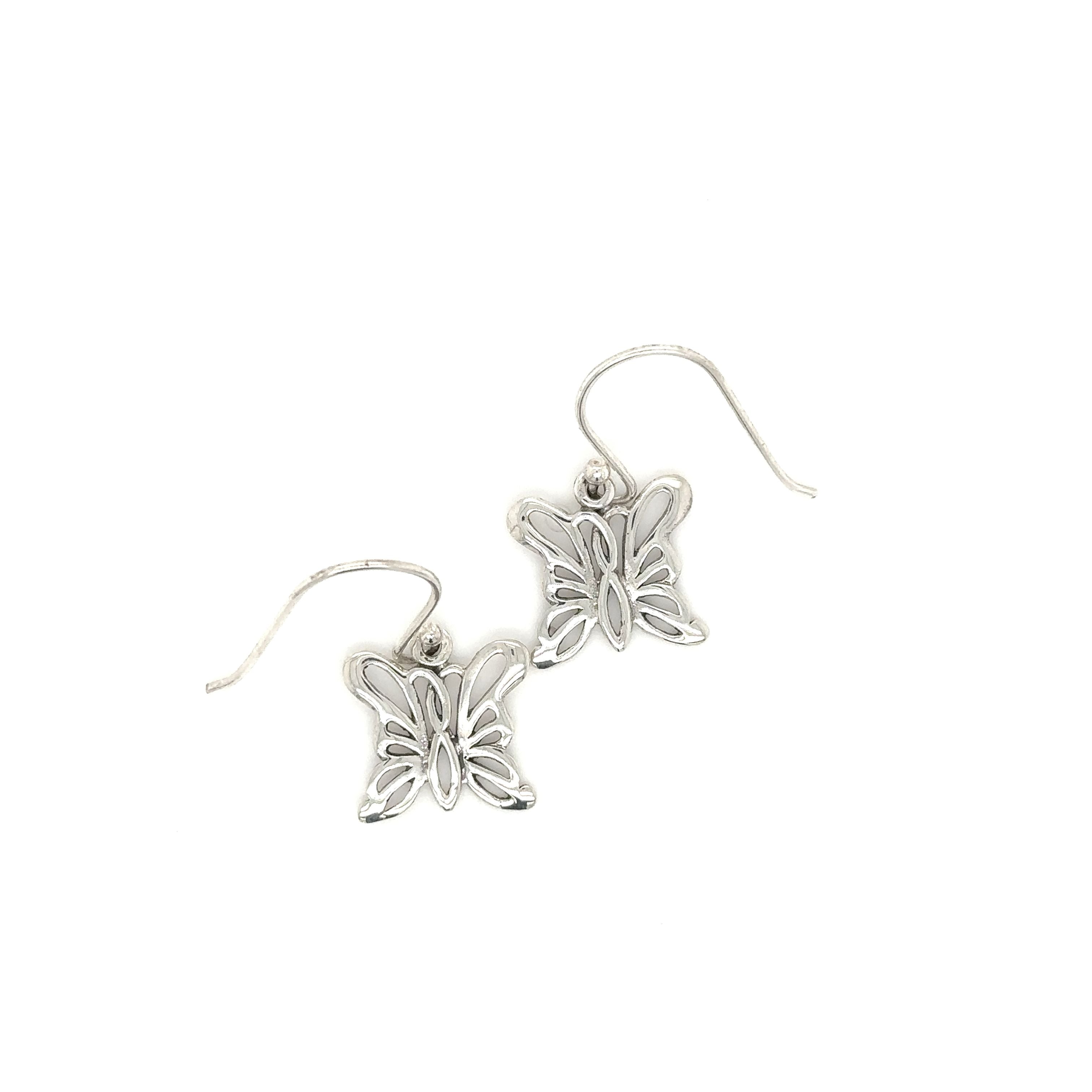 A pair of Simple Butterfly Outline Earrings by Super Silver on a white background, symbolizing hope and positivity.