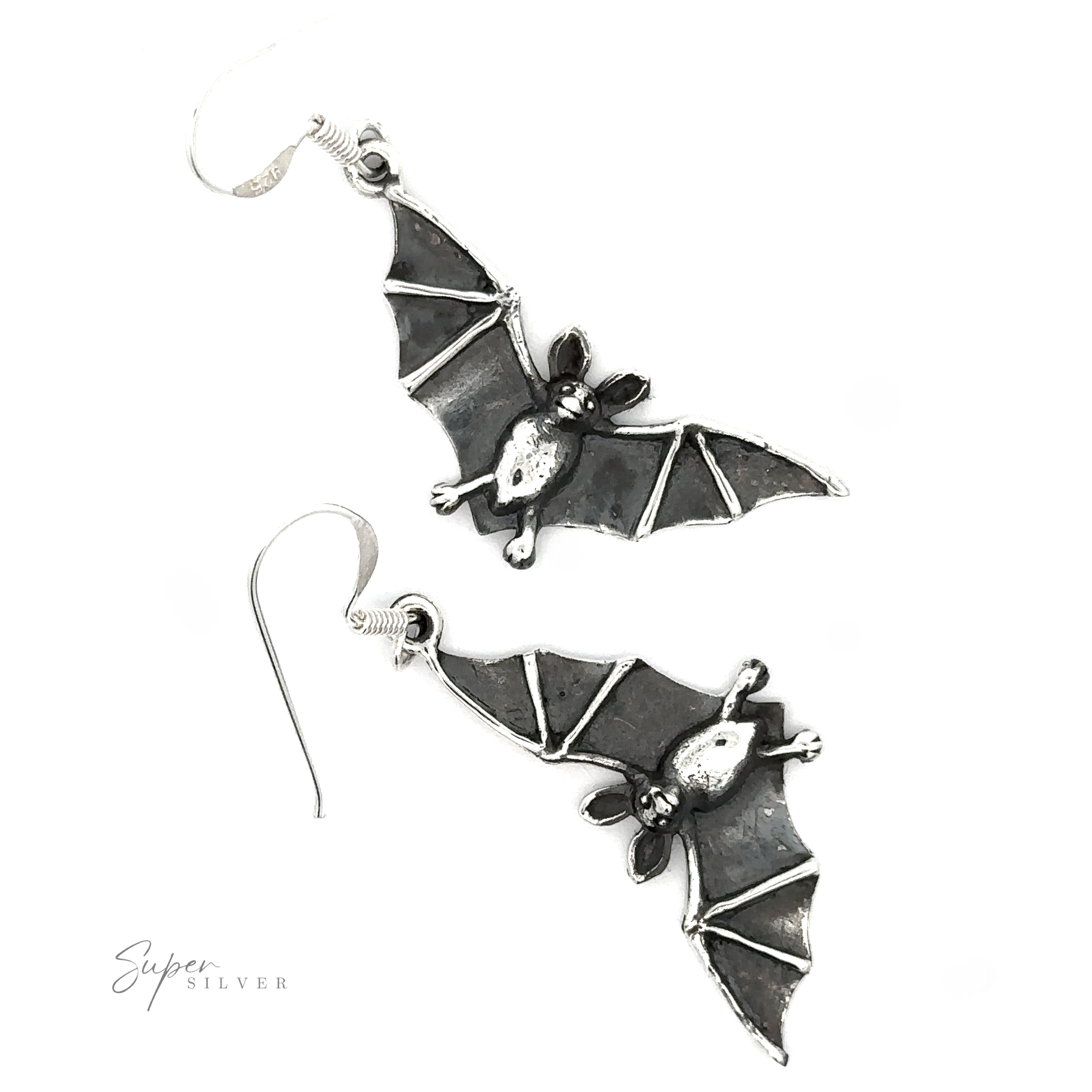 A pair of Flying Bat Earrings with a Gothic aesthetic and intricate details, displayed on a white background with a signature at the bottom right.