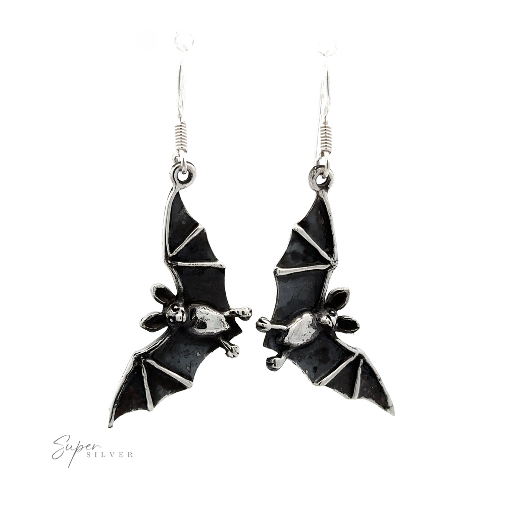A pair of Flying Bat Earrings with a Gothic aesthetic and a polished finish, hanging from simple hook wires, isolated on a white background.