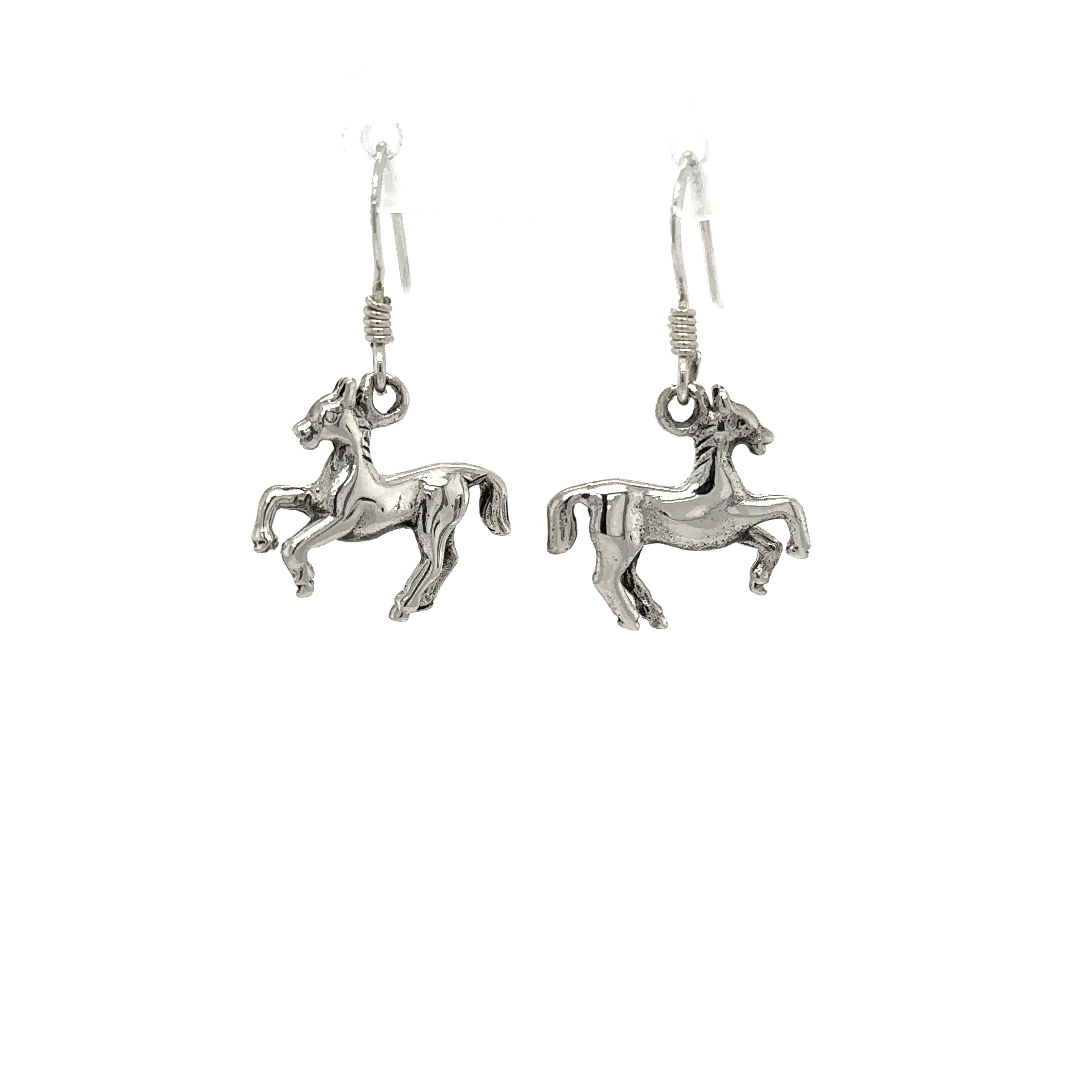 A pair of Super Silver sterling silver horse earrings on a white background.