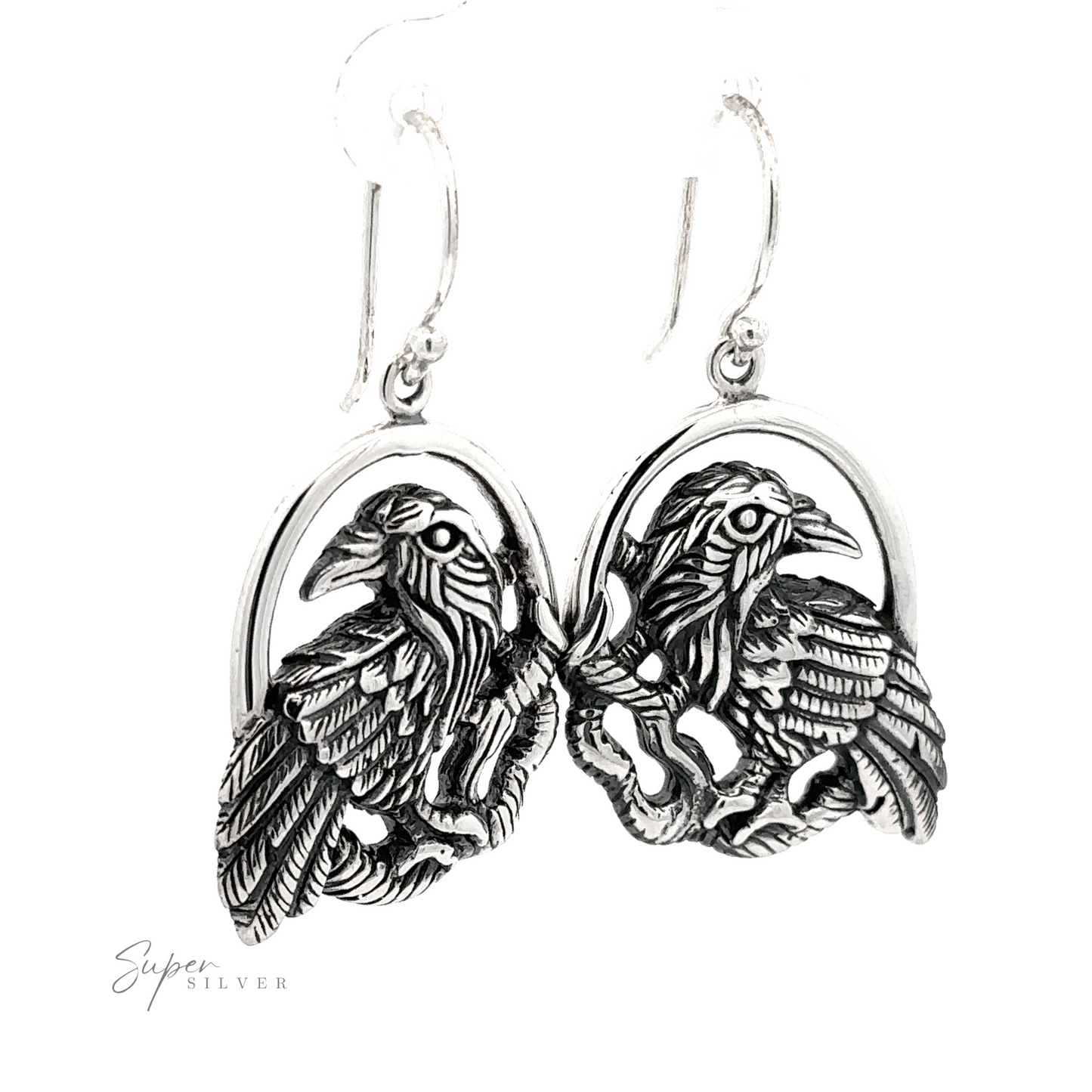 A pair of Detailed Raven Earrings, each featuring an intricate eagle design, on a white background with a "super silver" signature.