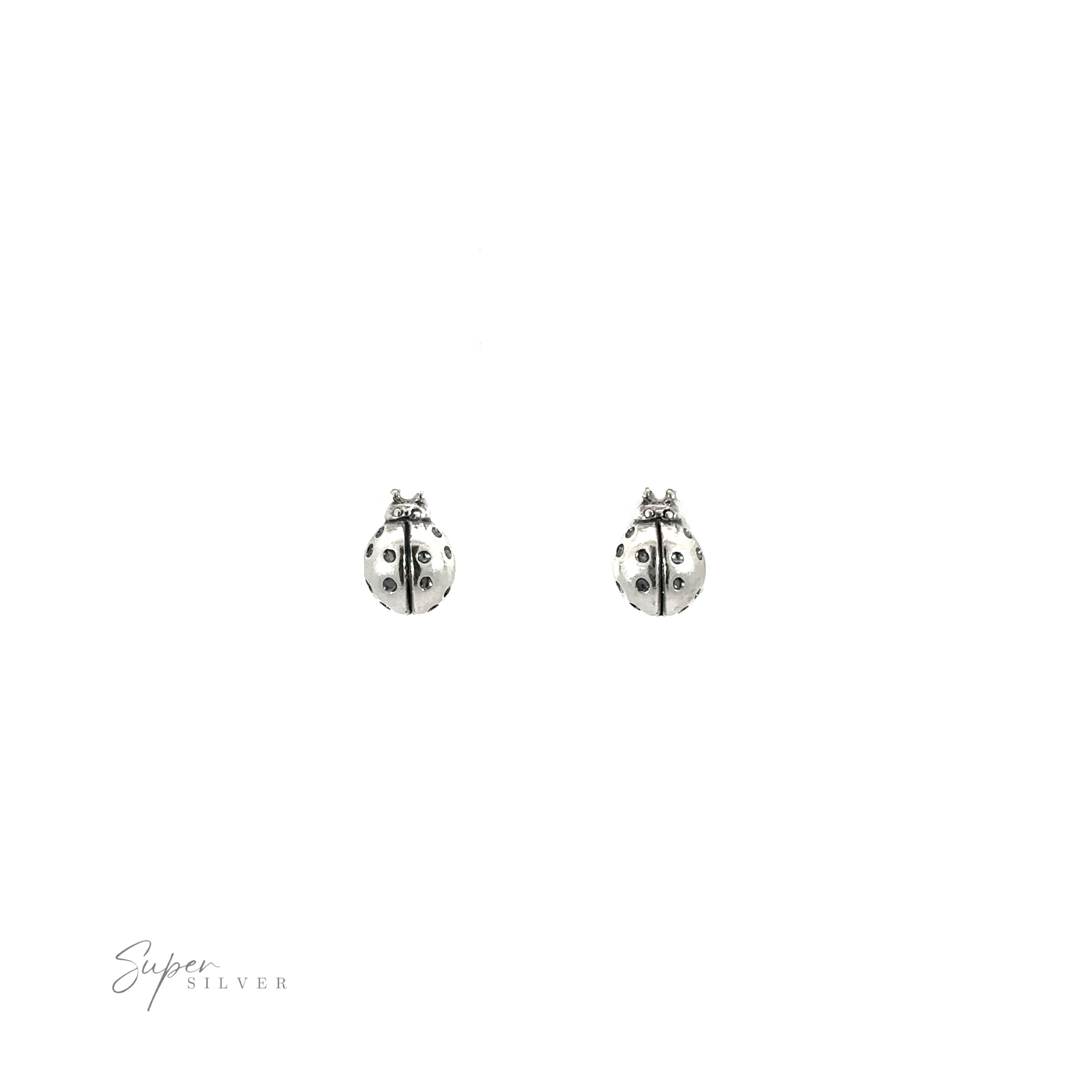 A pair of Ladybug Studs on a white background.