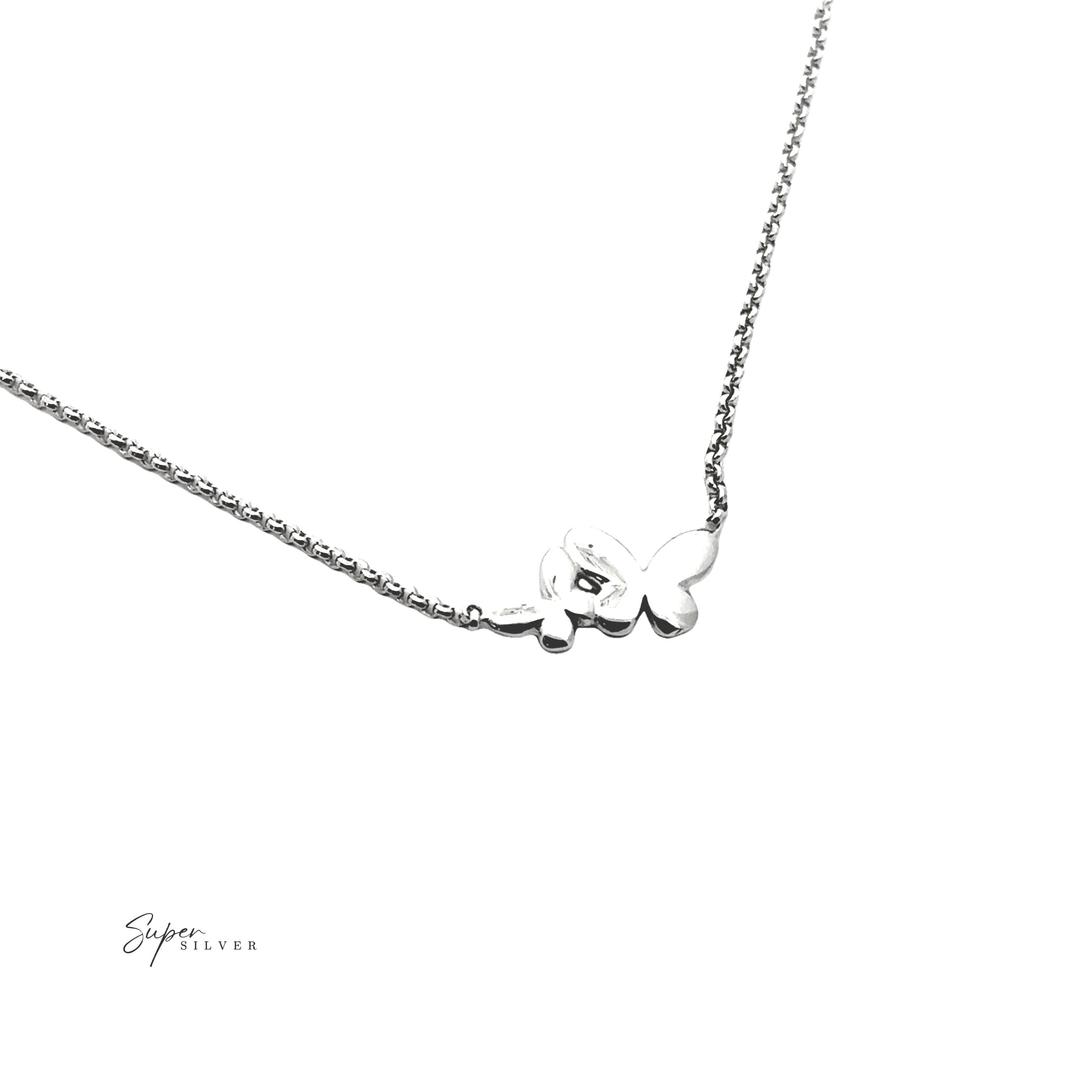 The Dainty Double Butterfly Necklace features a delicate .925 Sterling Silver chain with a small butterfly pendant, elegantly displayed against a white background.