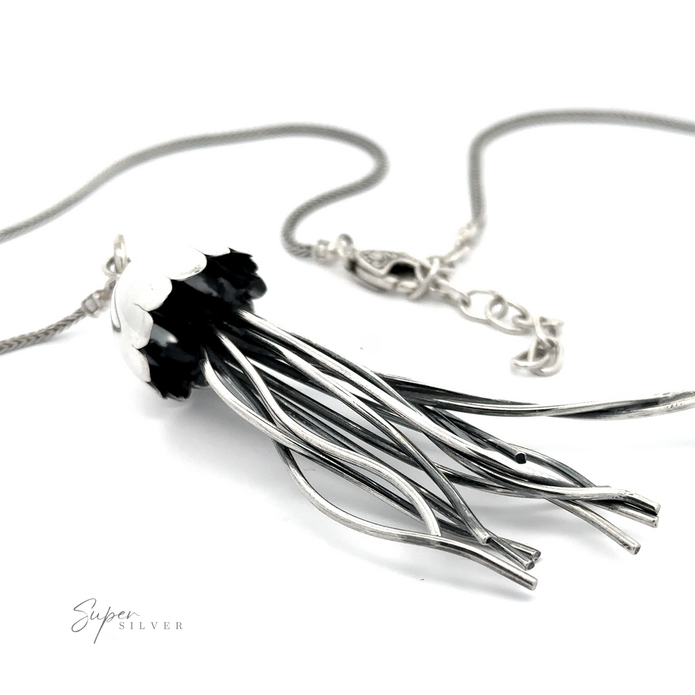 
                  
                    Jellyfish Necklace resembling a stylized bouquet of flowers with black and white petals, displayed on a white background with a sterling silver chain.
                  
                