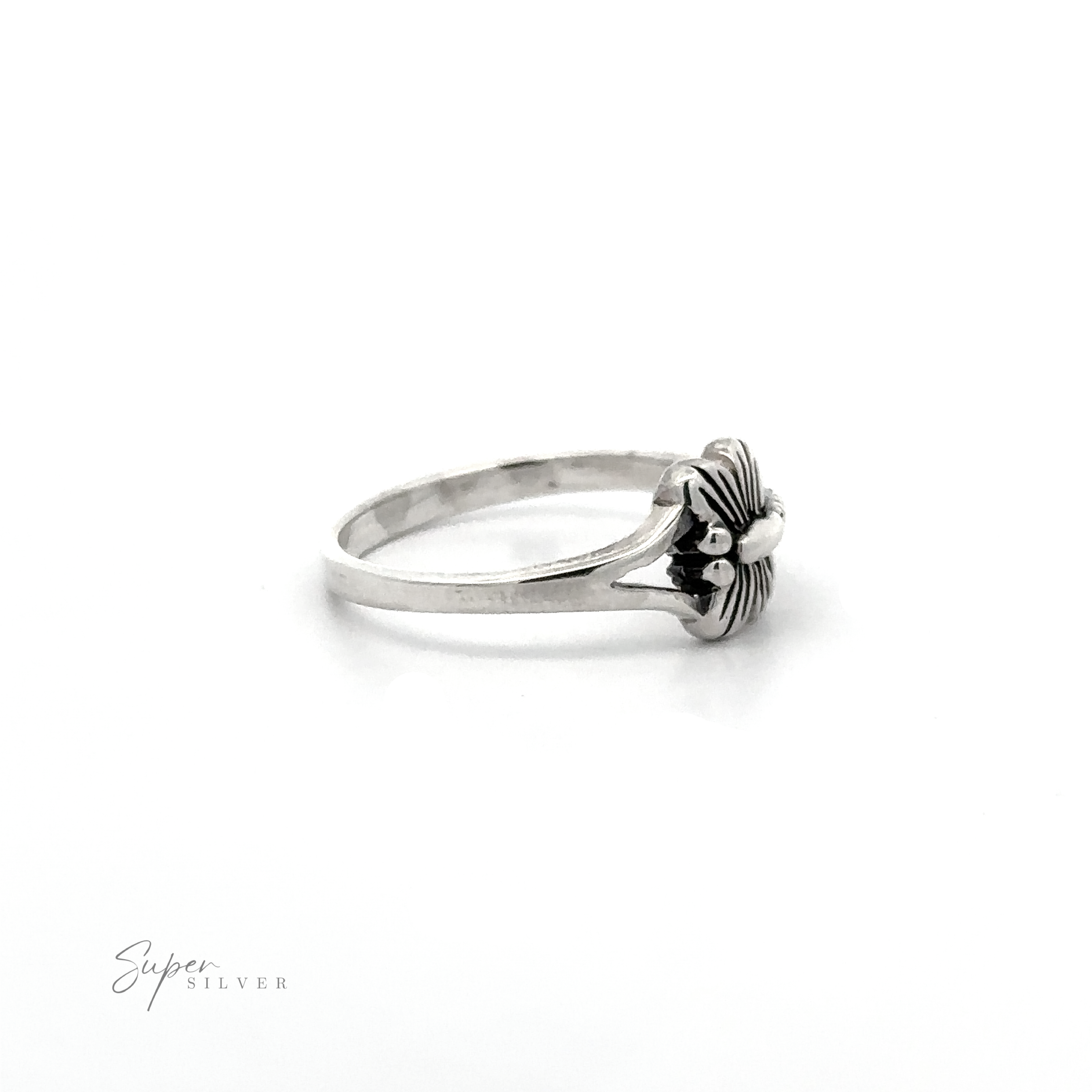 A delicate Small Dragonfly Ring with a flower on it.