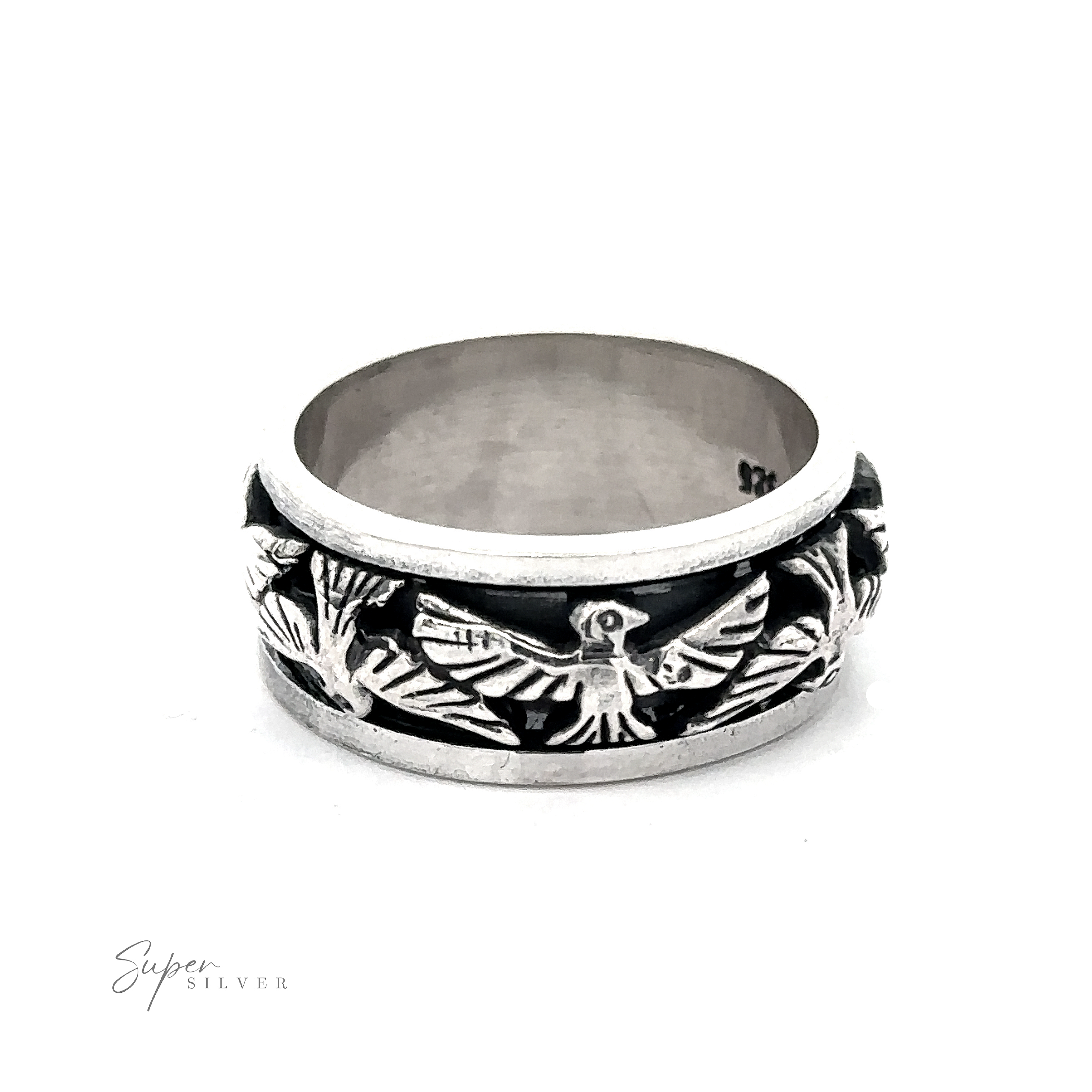 A Thick Thunderbird Spinner Ring featuring intricate, engraved designs with a floral and bird motif. The ring has a polished finish and a wide band.
