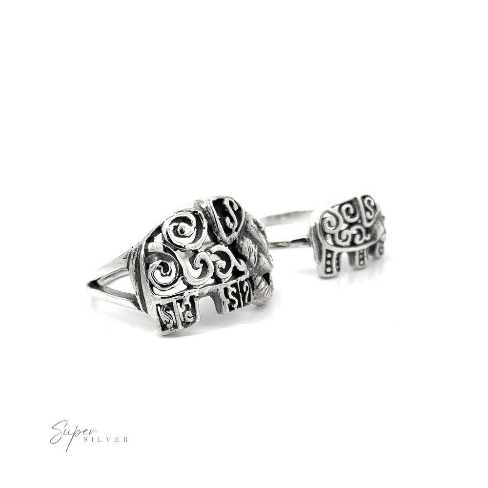 
                  
                    A pair of Filigree Elephant Rings with intricate swirl designs displayed against a white background.
                  
                