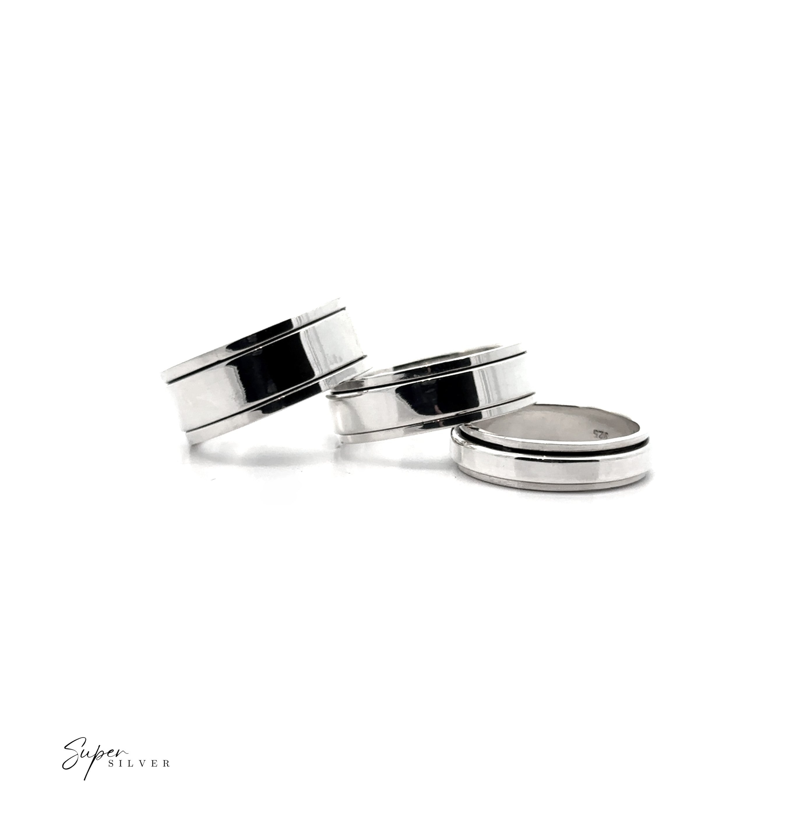 Three Simple Silver Spinner Rings, including a sleek spinning band, are displayed on a white background—one upright, two flat. "Super Silver" appears in the bottom left corner.