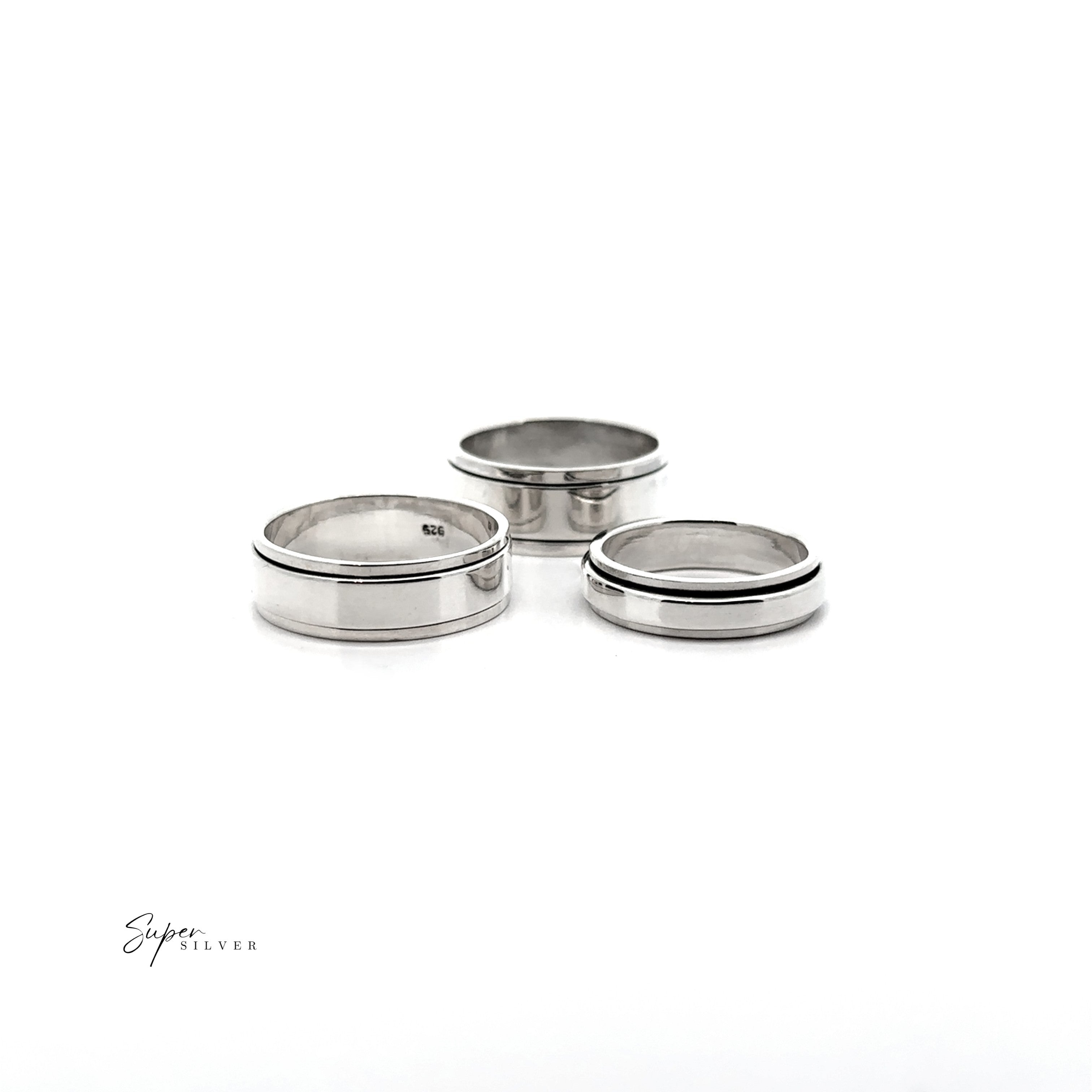 The Simple Silver Spinner Rings, three polished silver bands including a sleek spinner design, are displayed on a white background with "Slyer Silver" text in the lower left corner.