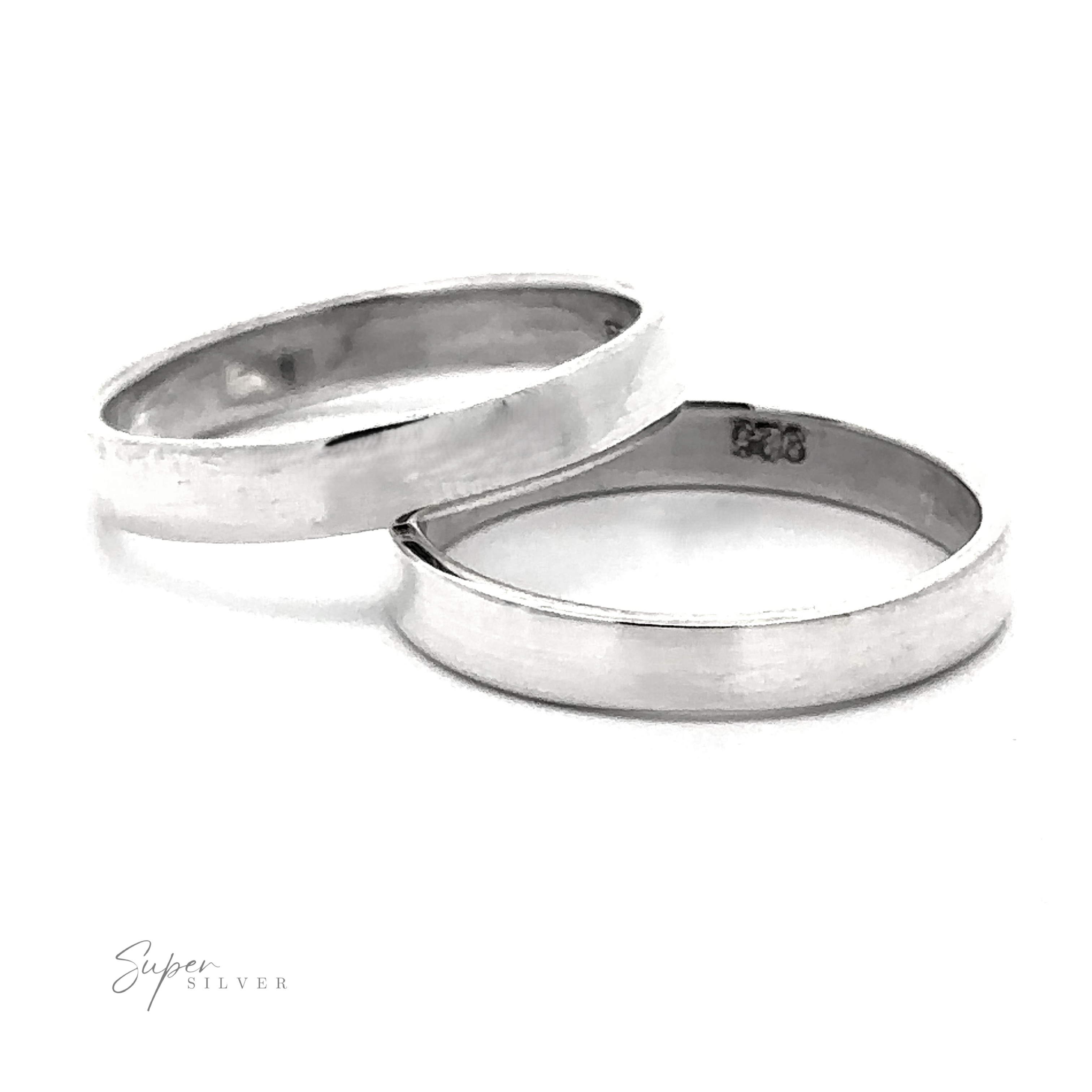 Two Minimalist Flat Band Rings rest side by side on a white background. One features a sleek sterling silver band with a straight edge, while the other has a curved edge—perfect versatile accessories for any style.