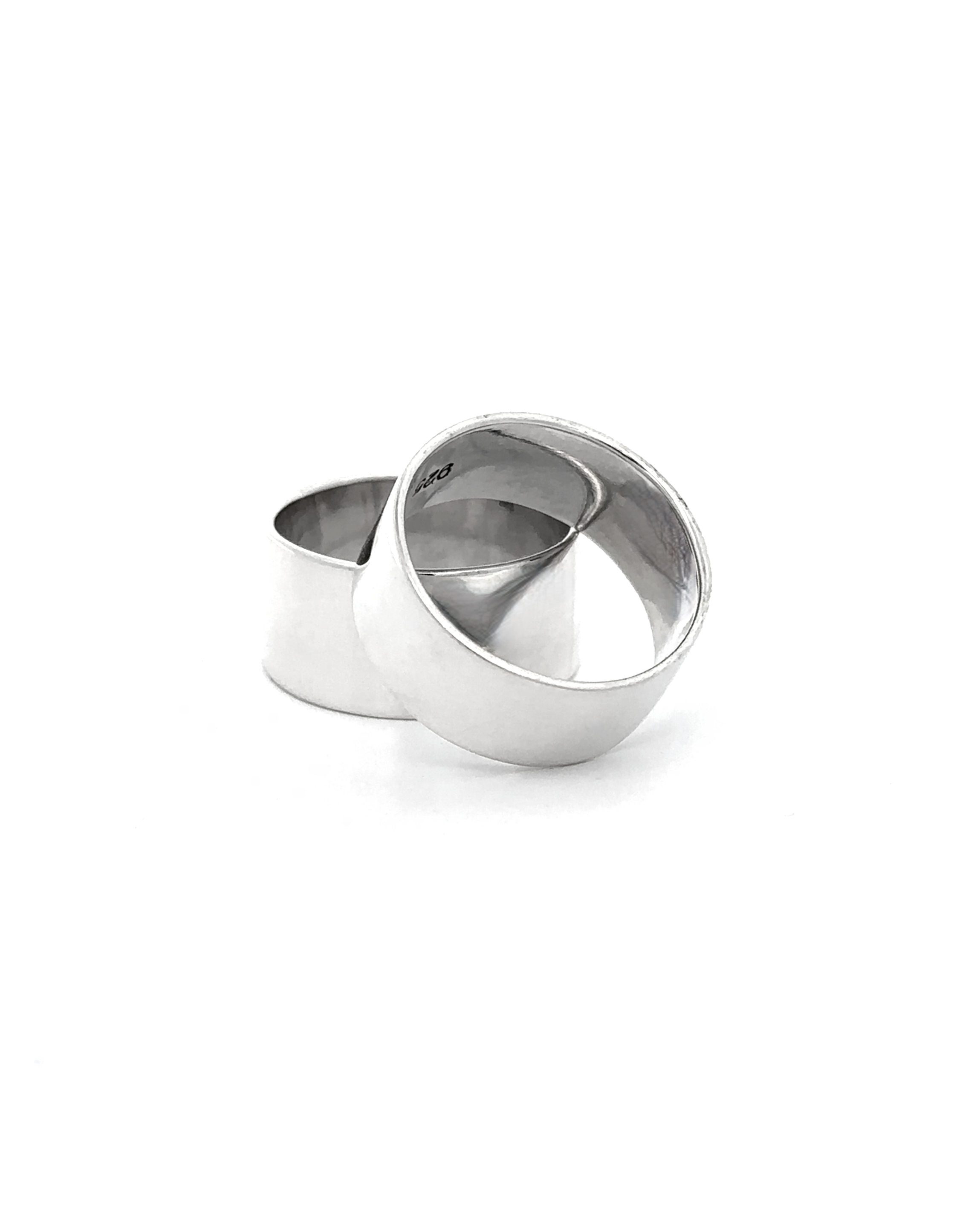 The Flat Band XL features two wide, polished .925 Sterling Silver rings overlapping on a white background, showcasing their bold flat band design and ultra-modern style.