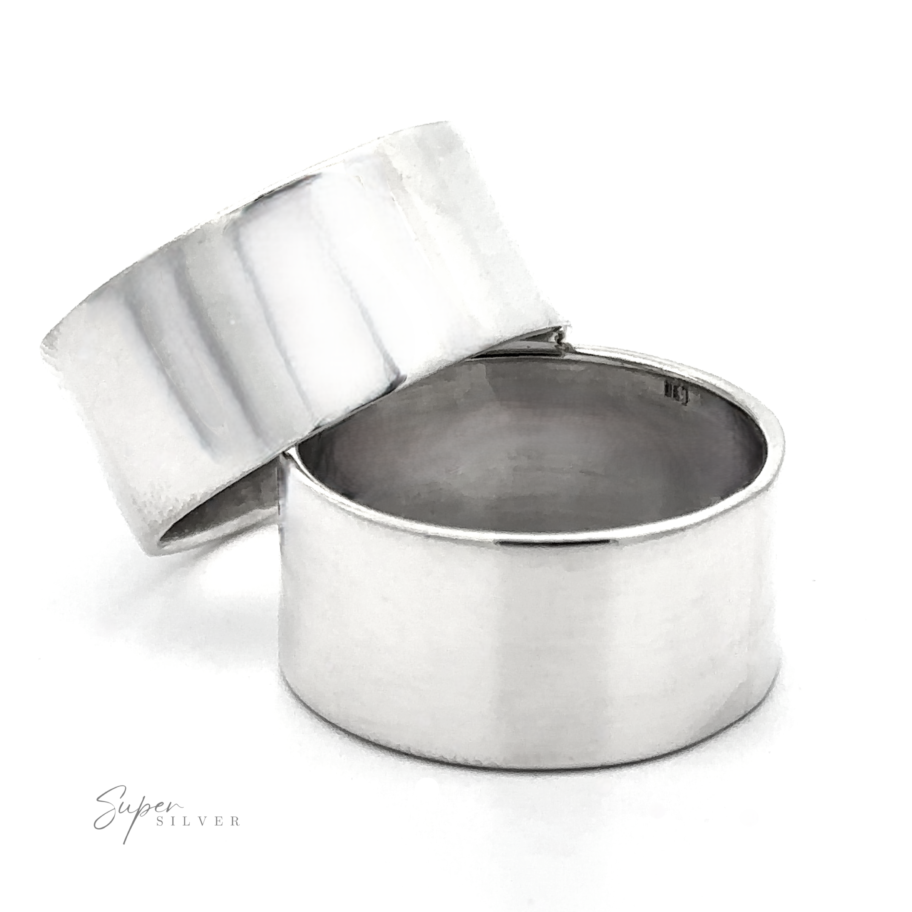 Two wide, plain .925 Sterling Silver bands—The Flat Band XL—are stacked on a white background. An ultra-modern ring style is highlighted, with "Super Silver" in small script at the bottom left and one bold flat band’s inside partially visible.