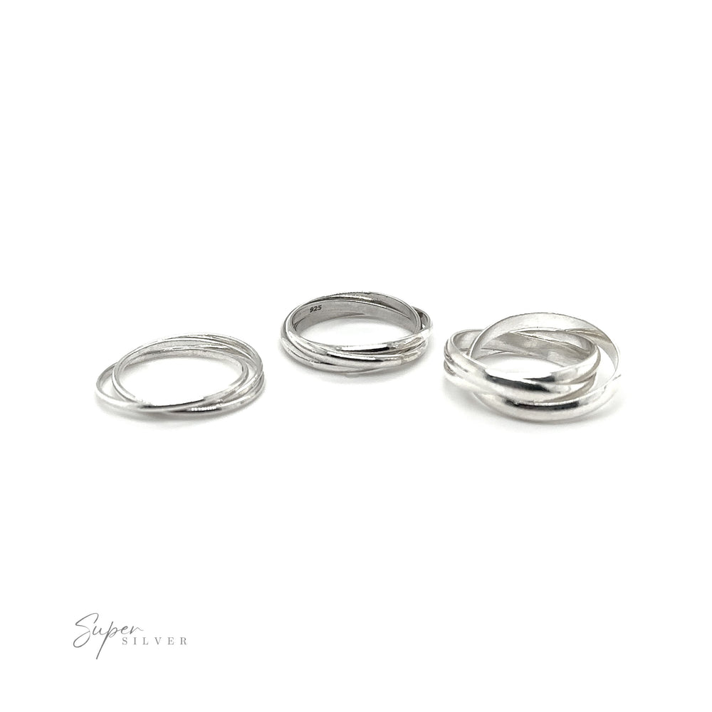 
                  
                    Three Three Ring Rolling Bands, symbolizing devotion, on a white background.
                  
                
