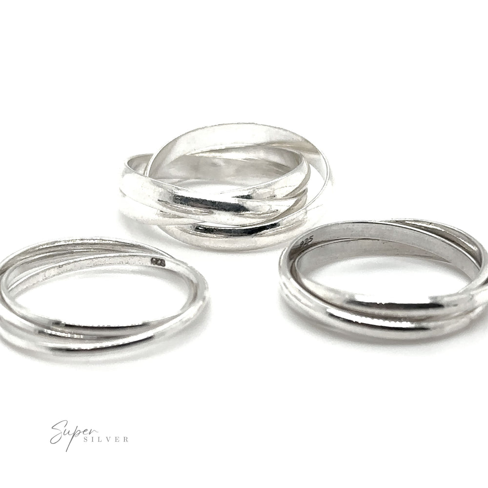 A Three Ring Rolling Bands showcasing symbolism and devotion, gleaming in silver hues against a pristine white background.