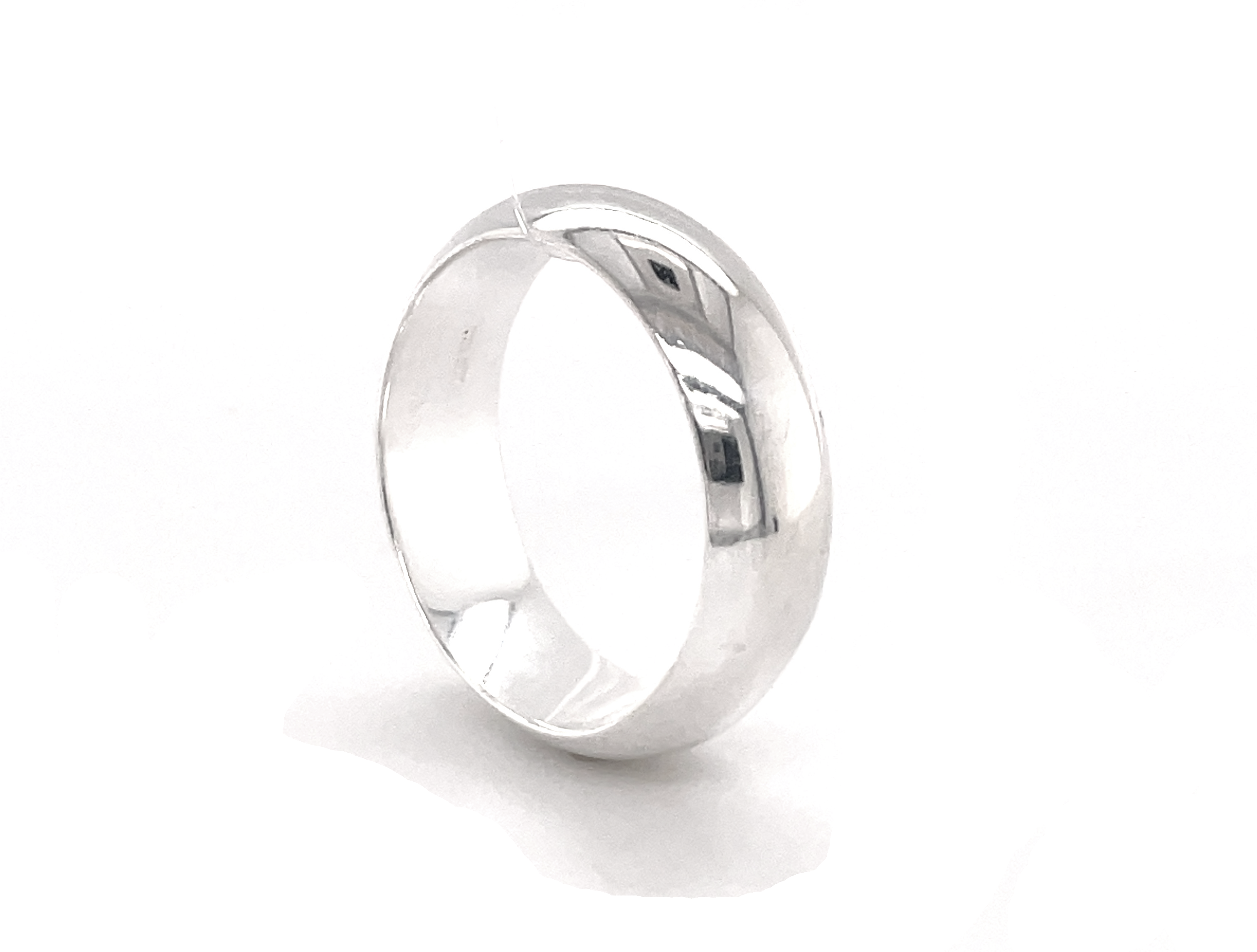 A 7mm Plain Band wedding ring with rounded band dimensions on a white background.
