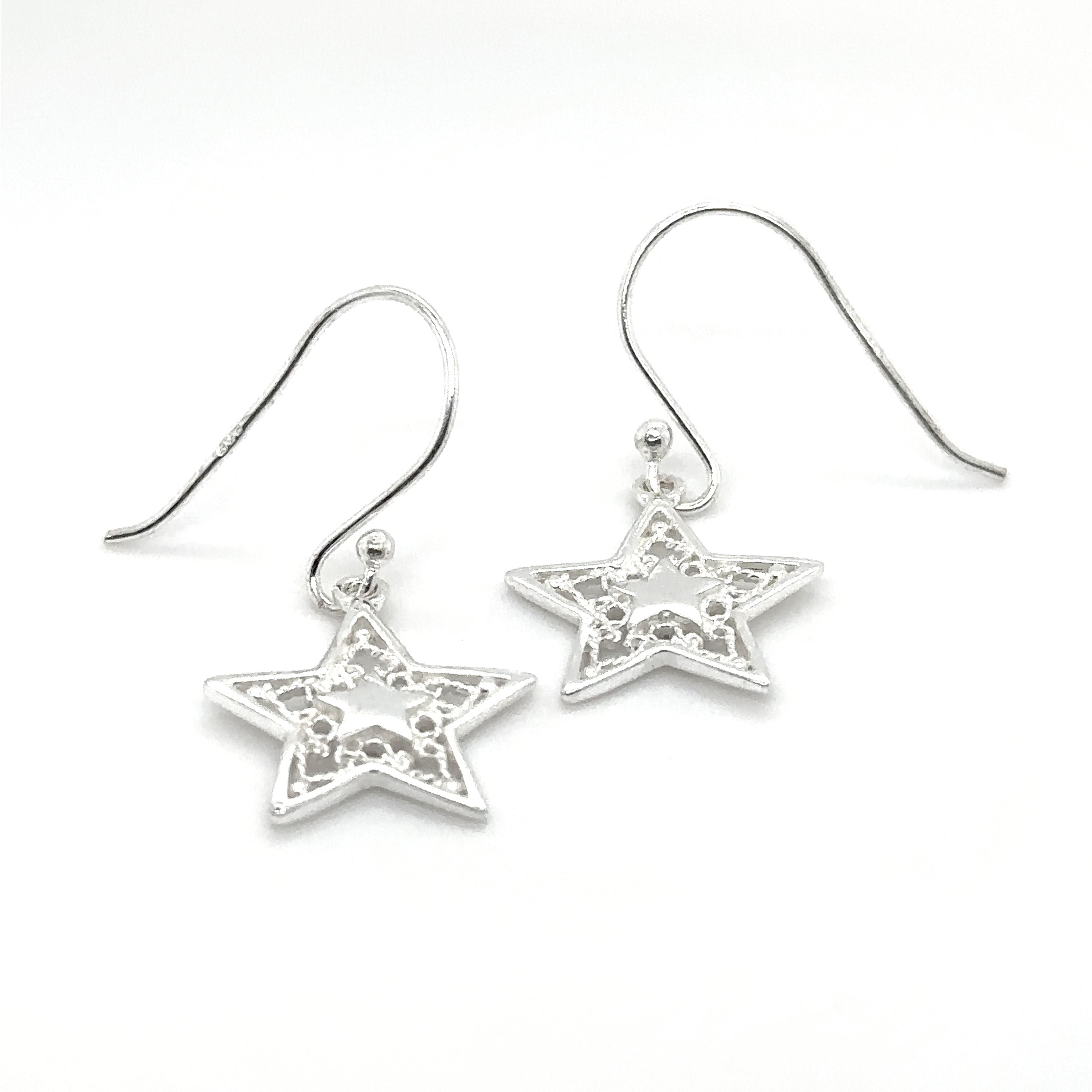 A pair of Super Silver Open Star Drop Earrings with Rope Design on a white background.