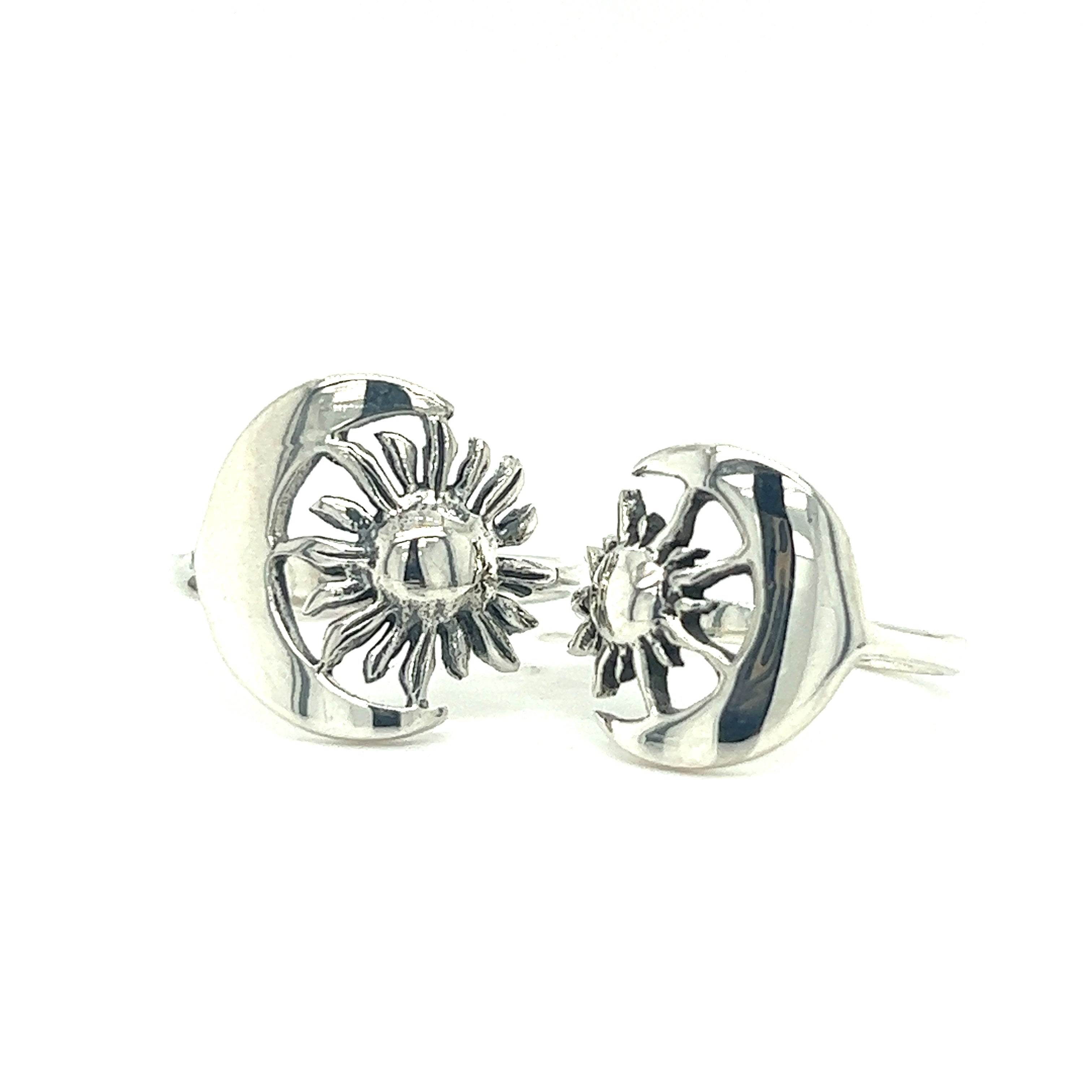 A pair of Striking Sun and Moon Rings by Super Silver, featuring celestial bodies, specifically a sun and moon, representing cosmic balance.