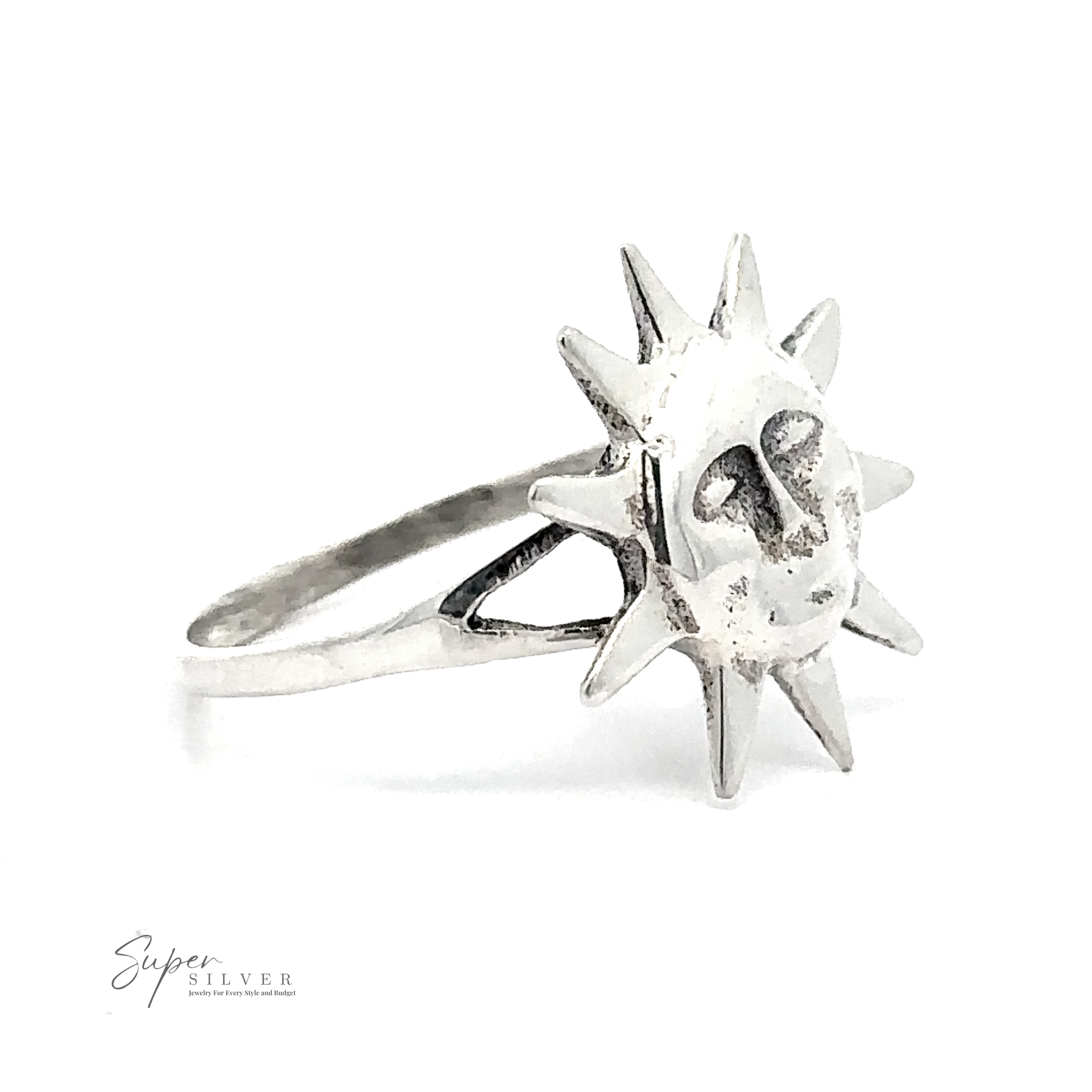 The Silver Sun Ring is a sterling silver ring adorned with a sun design that has a face on the front. The words "Super Silver" are printed in small font at the bottom left of the image.