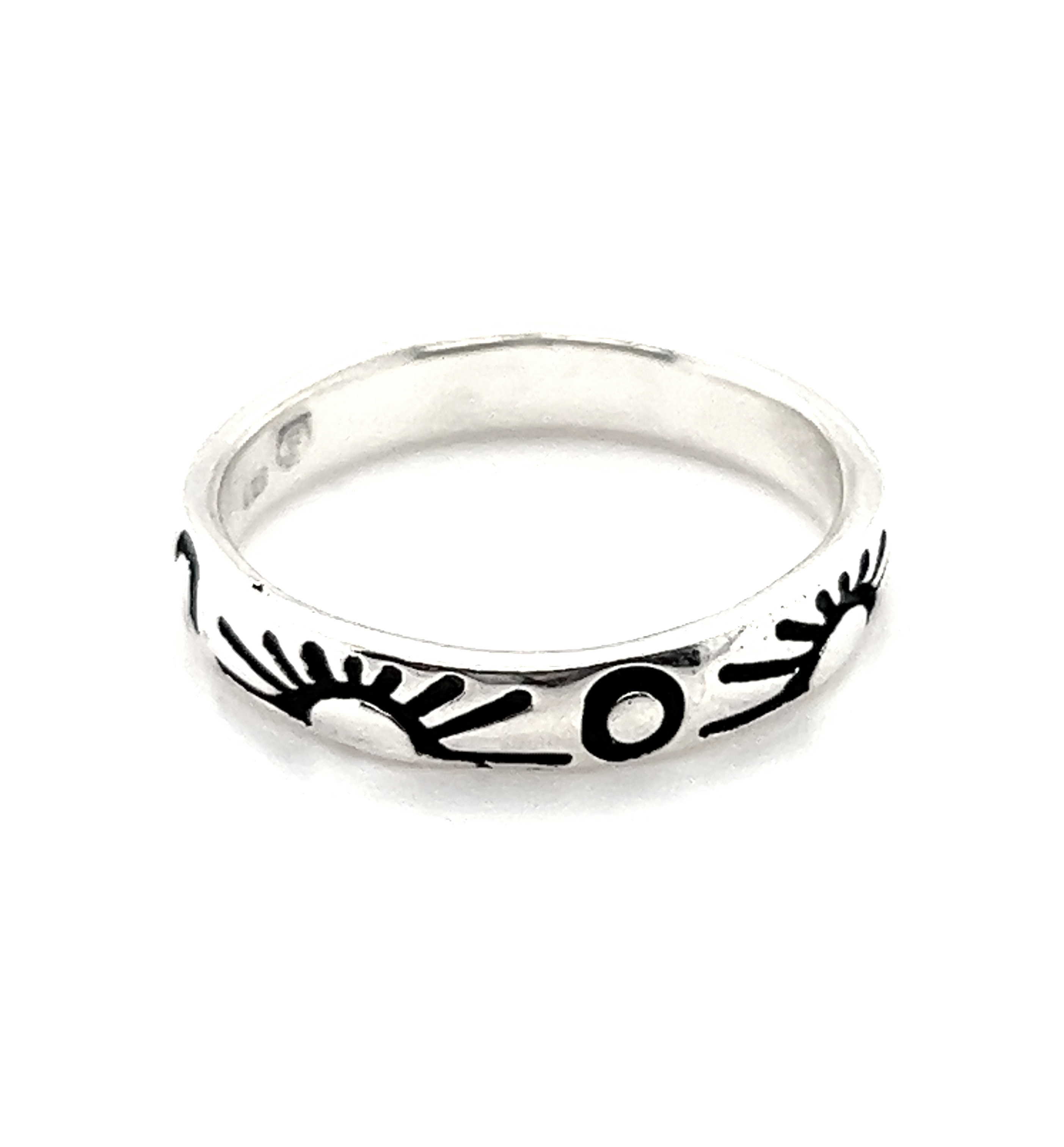 A Sun and Moon Etched Band Ring with black and white designs representing balance in life.
