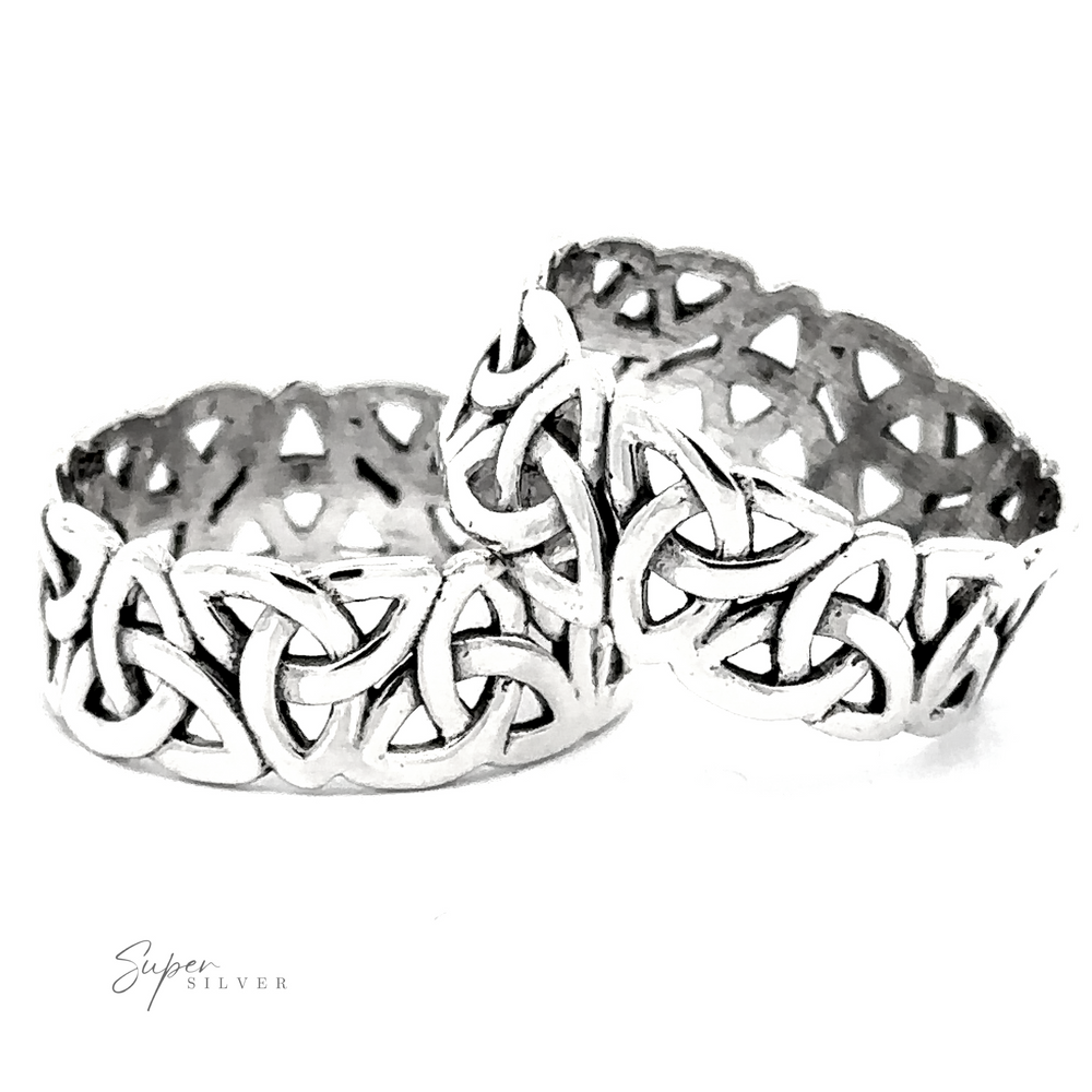 Wide Celtic Trinity Knot band rings on a white background.