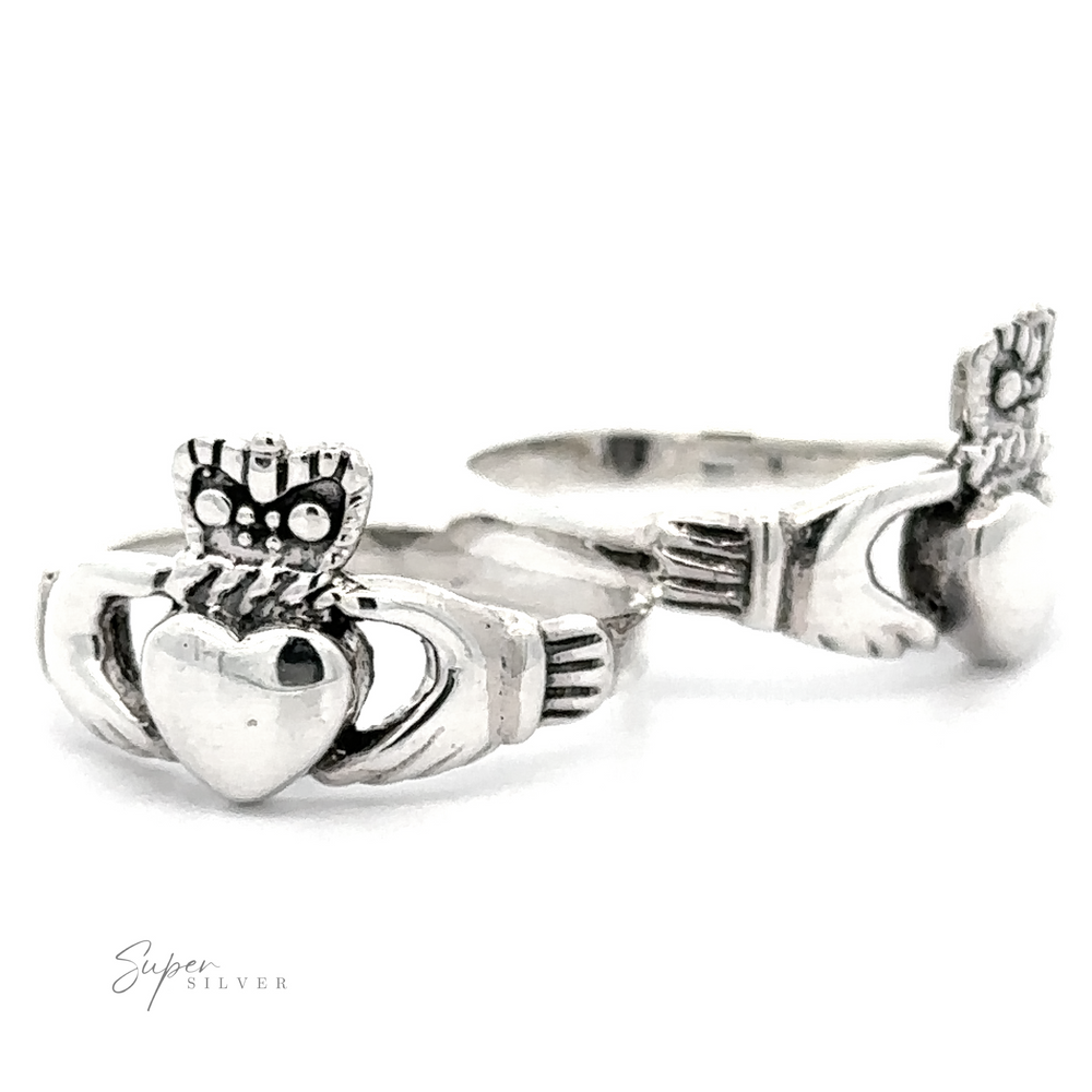 Silver Claddagh Ring featuring hands clutching a heart, and a crown atop, adorned with owl details on the crown and band.