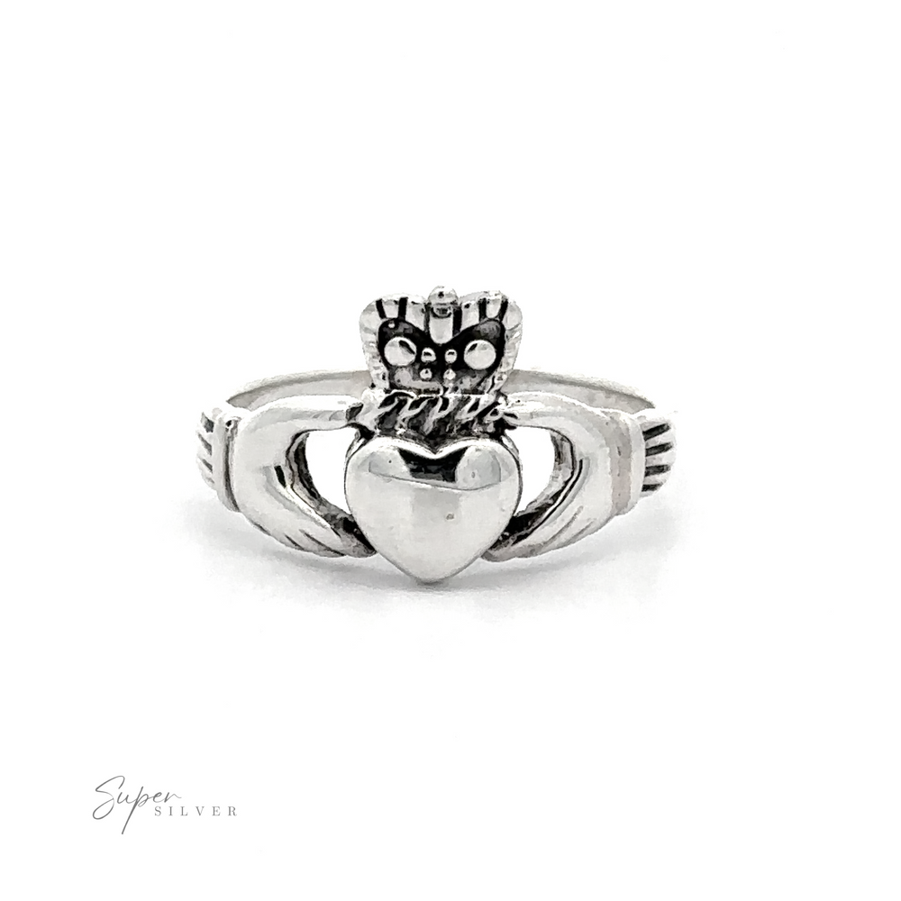 Silver Claddagh Ring featuring a heart held by two hands with a crown on top, displayed against a white background.