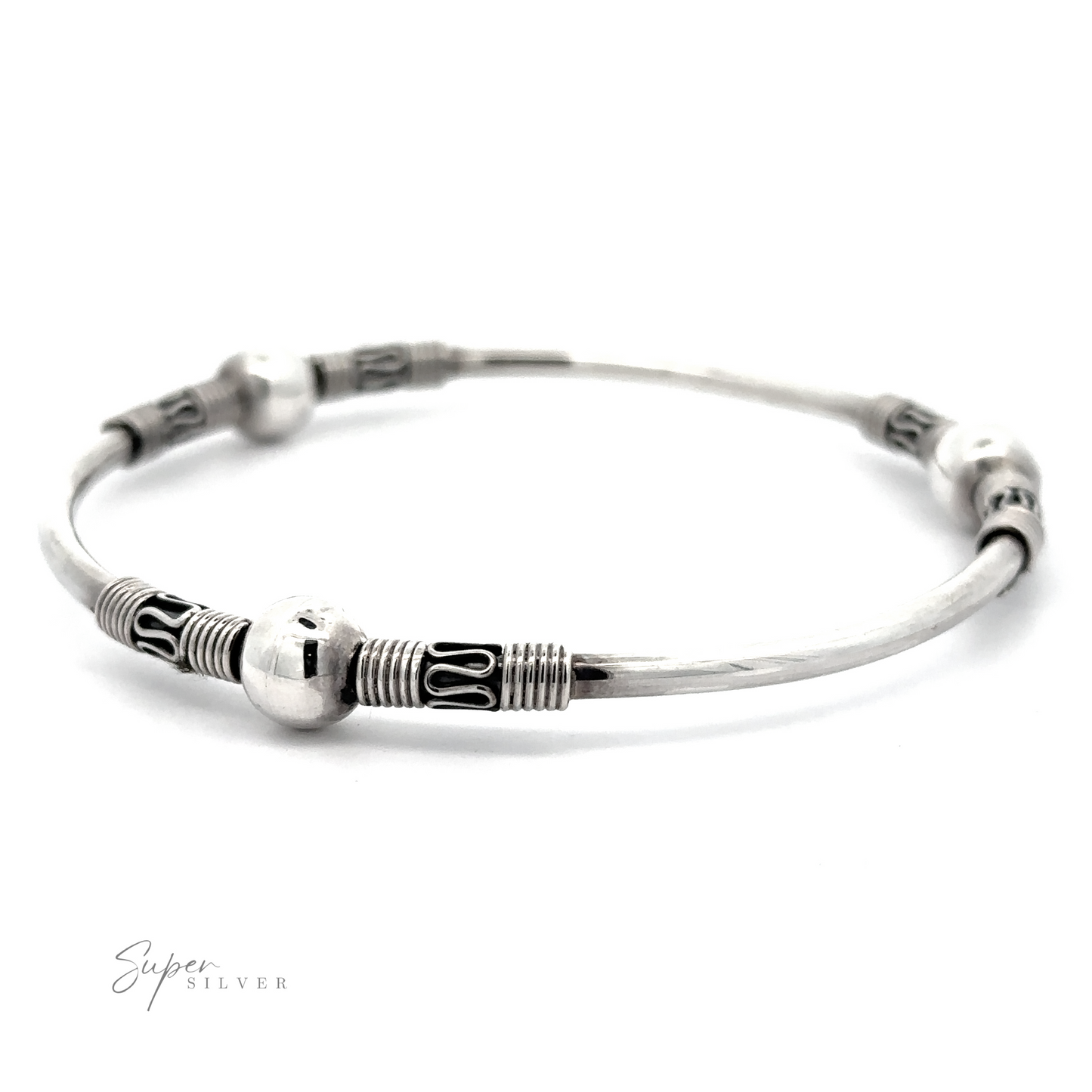 
                  
                    This Silver Bali Style Bangle Bracelet features decorative spherical beads and intricate etched designs, reminiscent of a Balinese style bangle.
                  
                