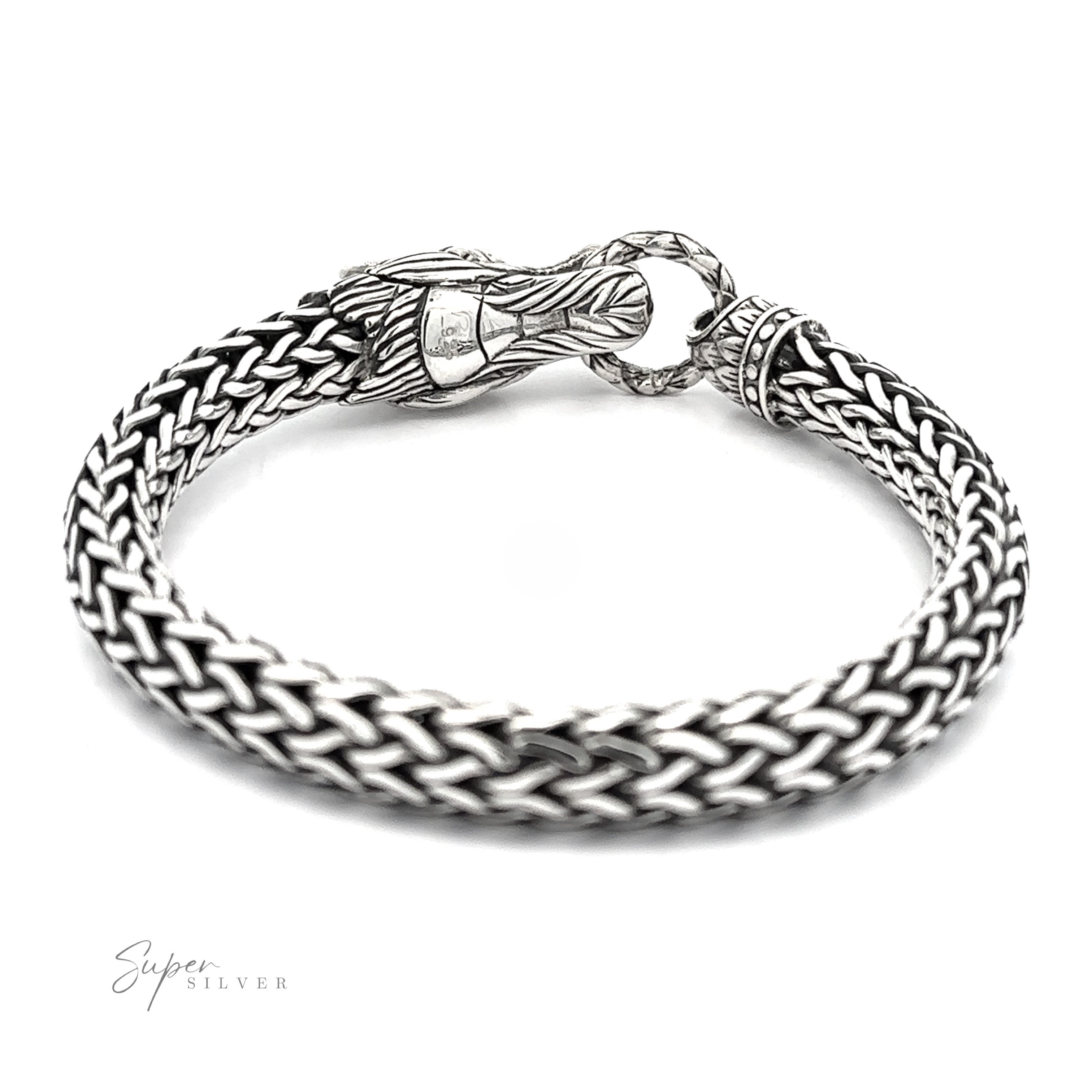 A Sterling Silver Braided Rope Bracelet with Dragon Head featuring a clasp designed to resemble a dragon's head biting a ring, this bold statement piece is sure to capture attention.