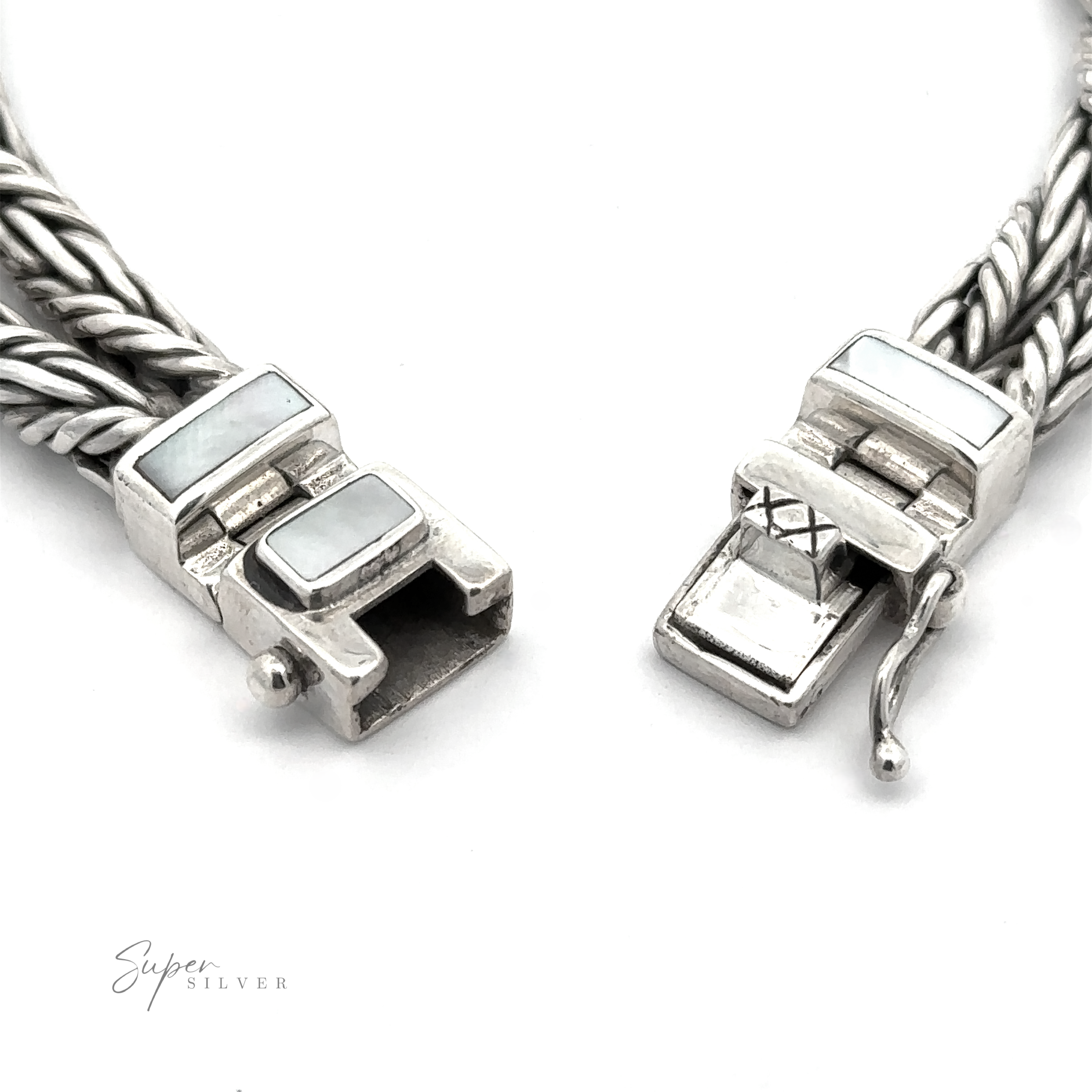 Close-up of a .925 Sterling Silver clasp mechanism on a white background showing intricate metalwork, rectangular stone inlays, and the elegant design of a Double Twisted Braided Rope Bracelet incorporating Red Coral elements.