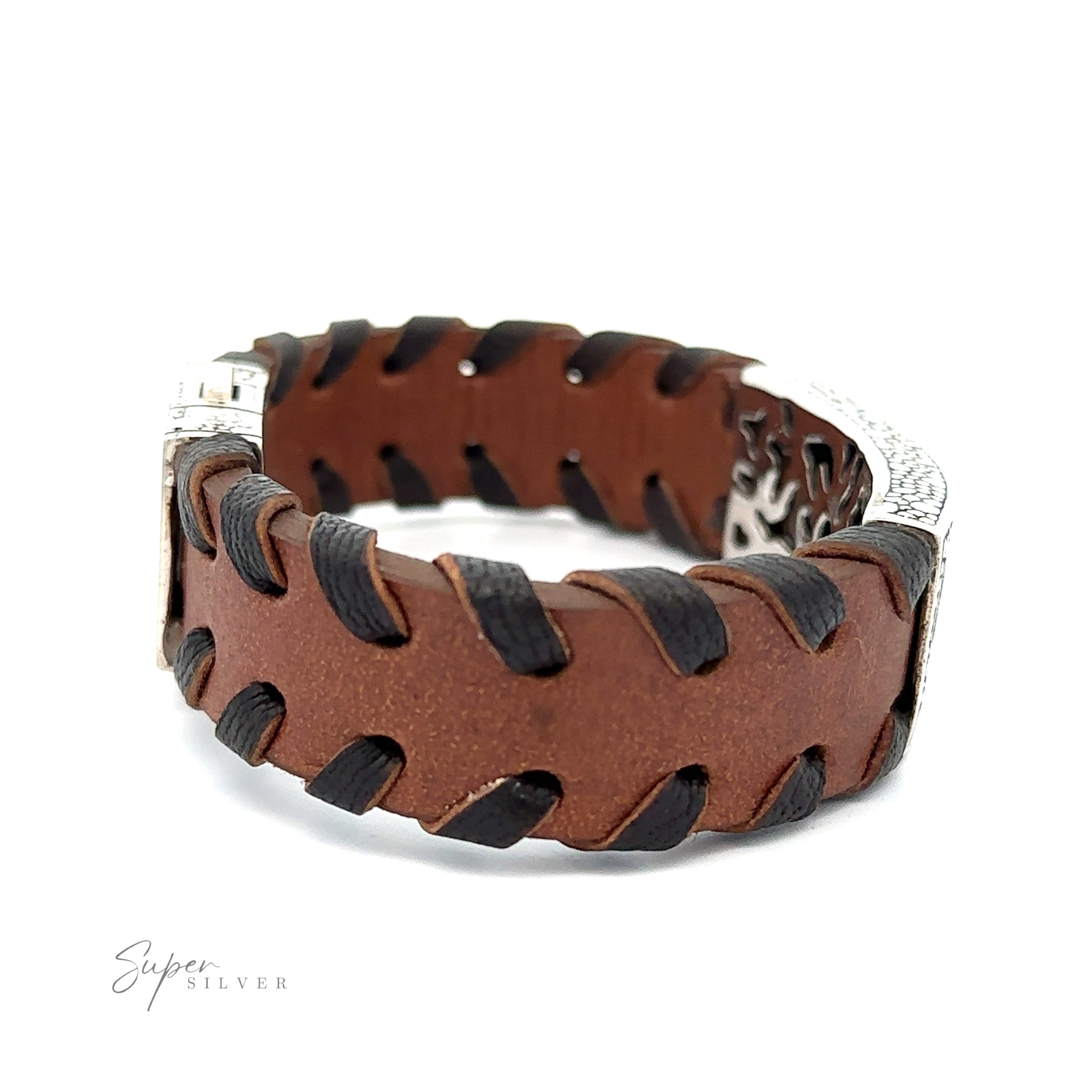 A Tribal Leather Bracelet with black interweaving details, featuring a decorative tribal silver center and a sleek silver clasp. Branding text "Super Silver" appears in the lower left corner.