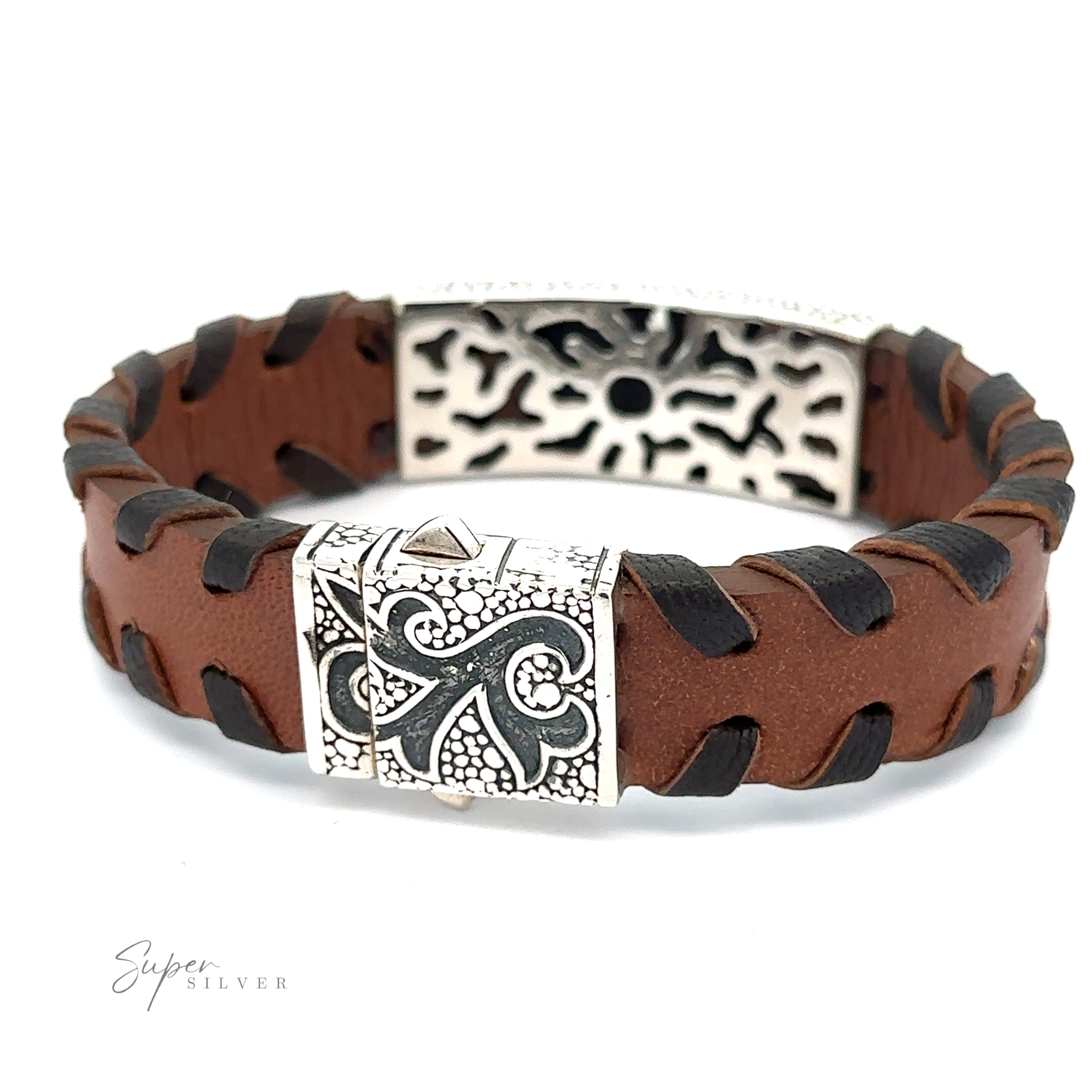 A Tribal Leather Bracelet with black threading and silver decorative clasps featuring intricate designs. The bracelet showcases a tribal silver center and has an embossed logo, "Super Silver," in the bottom left corner.