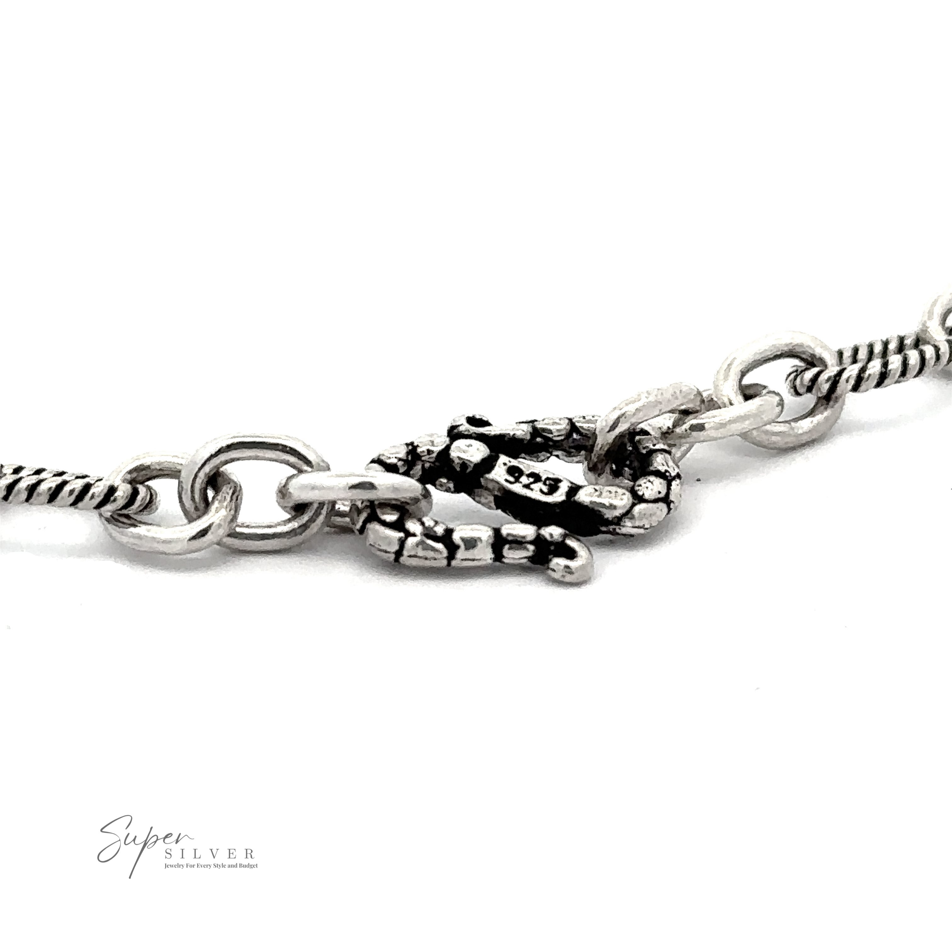 Close-up of a Lasso and Rolo Bracelet featuring an intricate clasp design shaped like a lobster claw, with the brand name "Super Silver" visible in the corner, showcasing exquisite Balinese artistry.