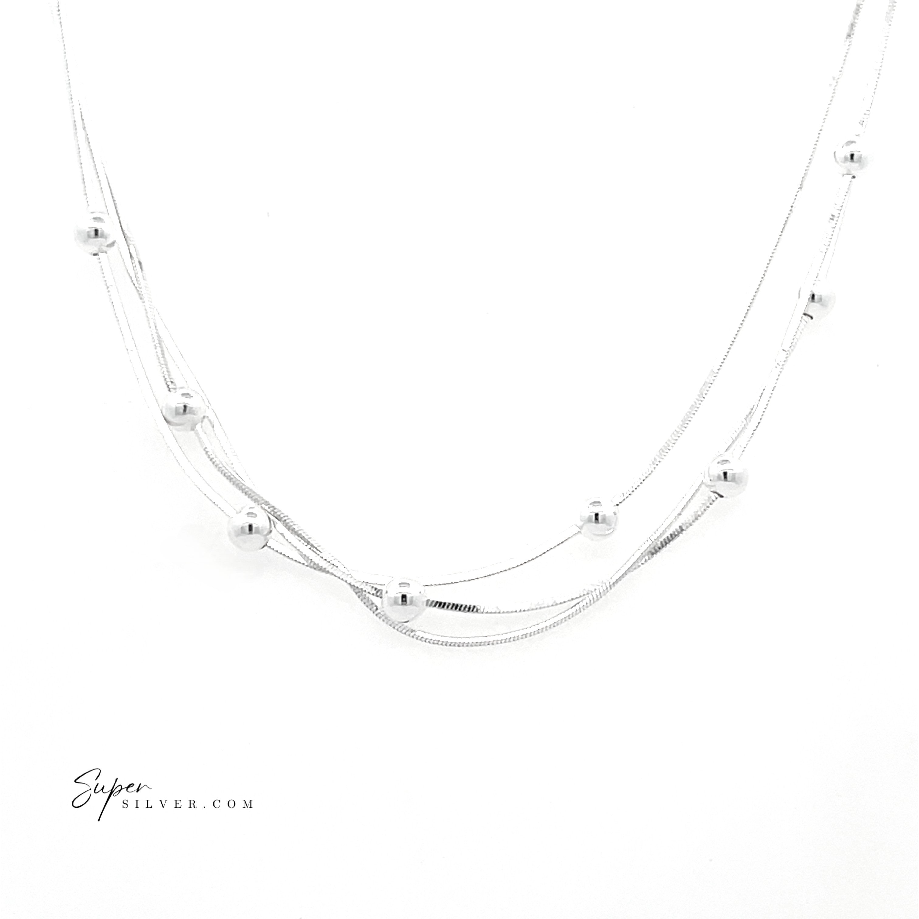The Silver Serenade Necklace features three Italian silver snake chains adorned with small round beads, shown on a white background. The "SuperSilver.com" logo is displayed in the bottom left corner.