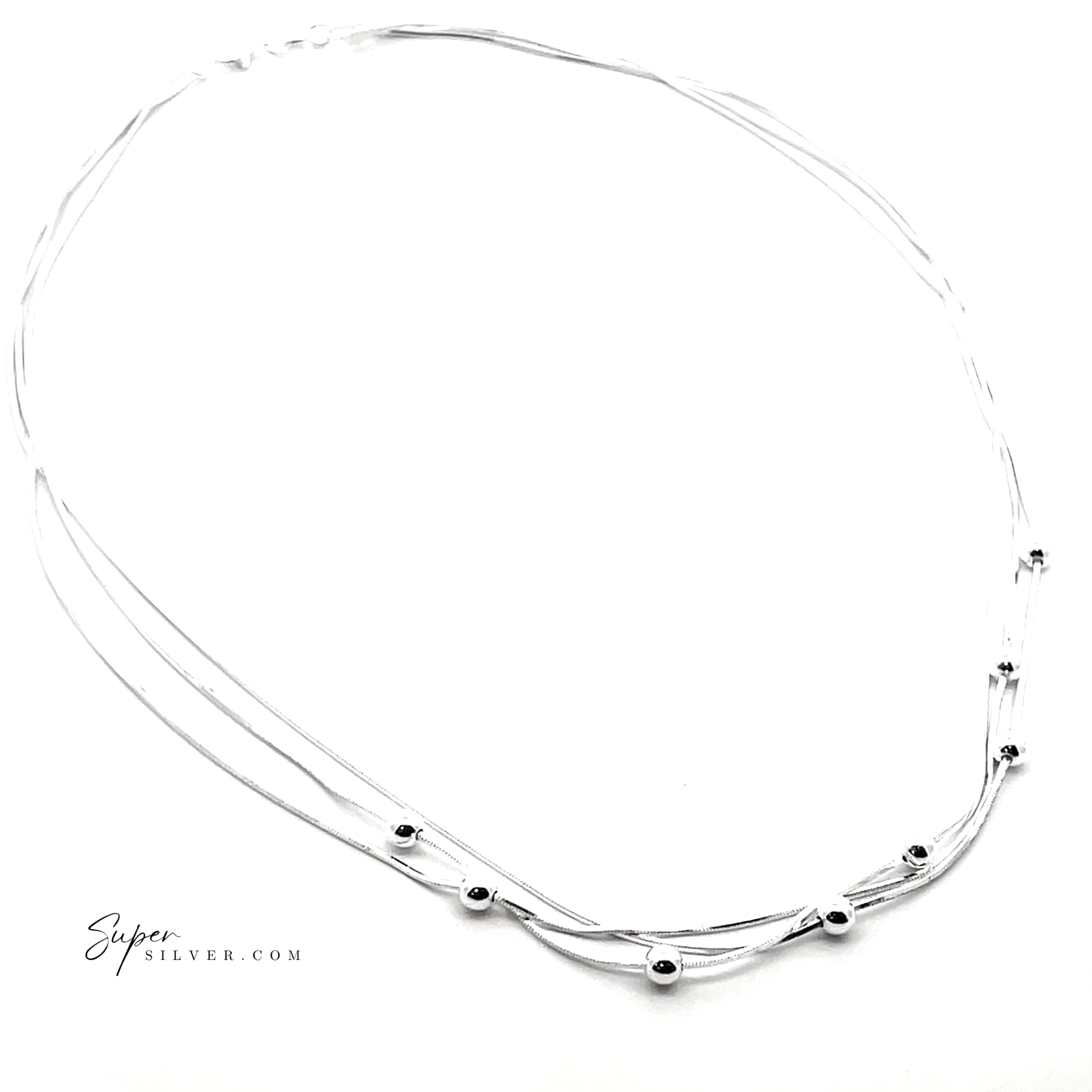 The Silver Serenade Necklace features three slender Italian silver chains, including a delicate snake chain, layered with small silver beads. Displayed on a white background with "Supersilver.com" in the bottom left corner.