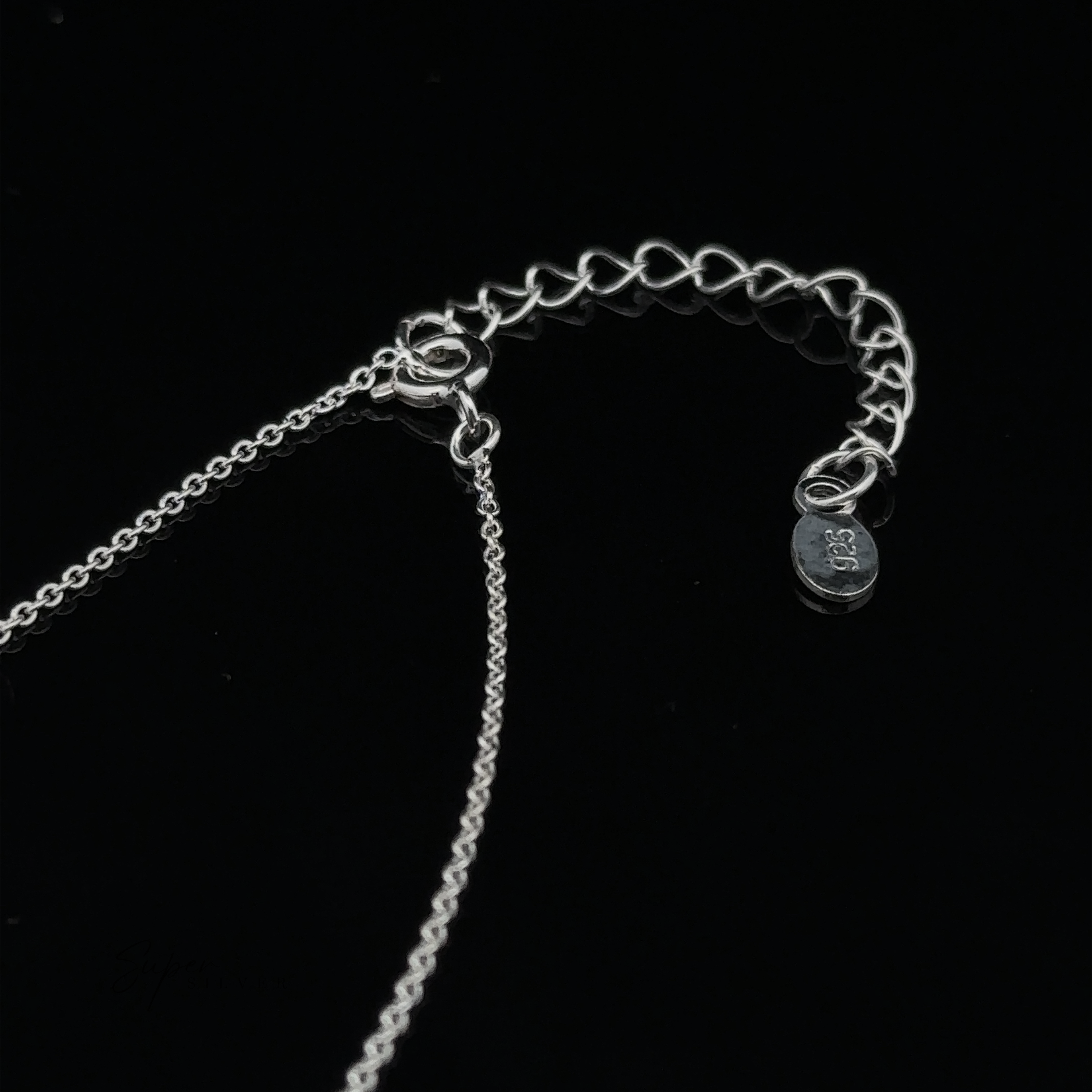 Double Circle Necklace with a chain and clasp set against a black background. The chain includes an extender and a small tag inscribed with ".925 Sterling Silver." This elegant piece symbolizes an eternal bond, perfect for any occasion.