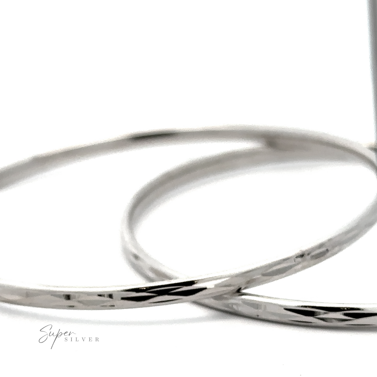 
                  
                    Two Flashy 60mm Diamond Faceted Hoops with a hammered texture, displayed against a white background.
                  
                