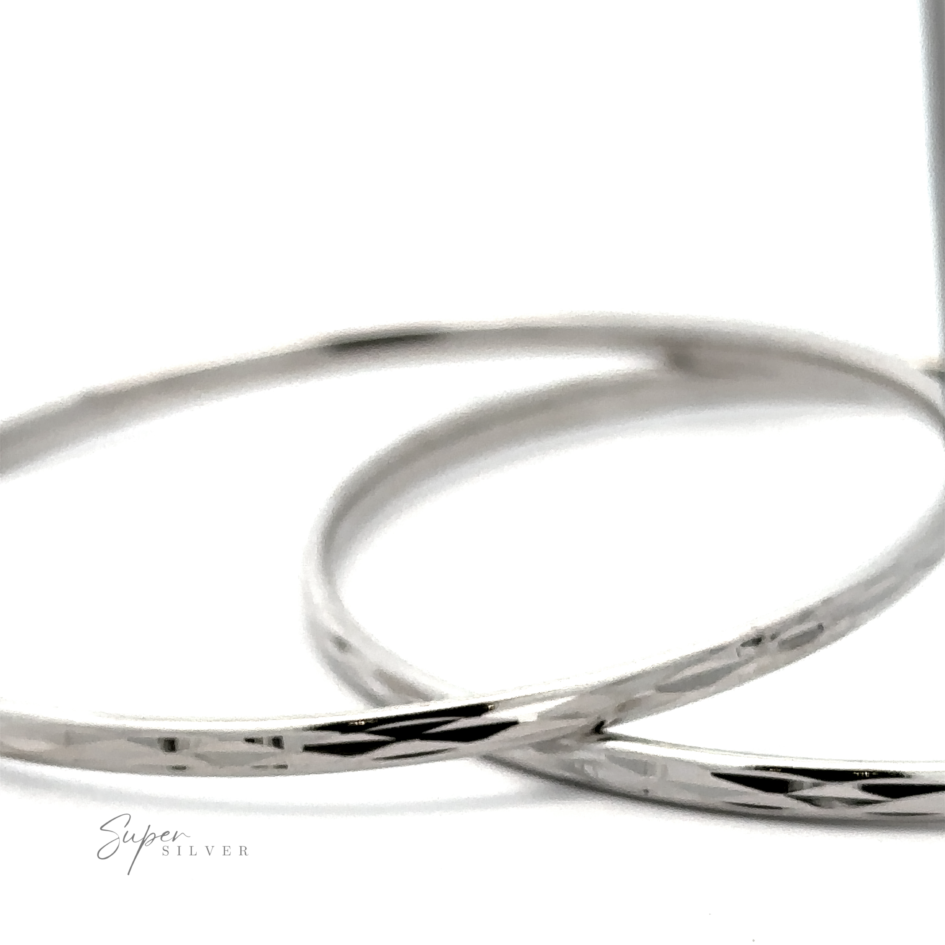 Two Flashy 60mm Diamond Faceted Hoops with a hammered texture, displayed against a white background.