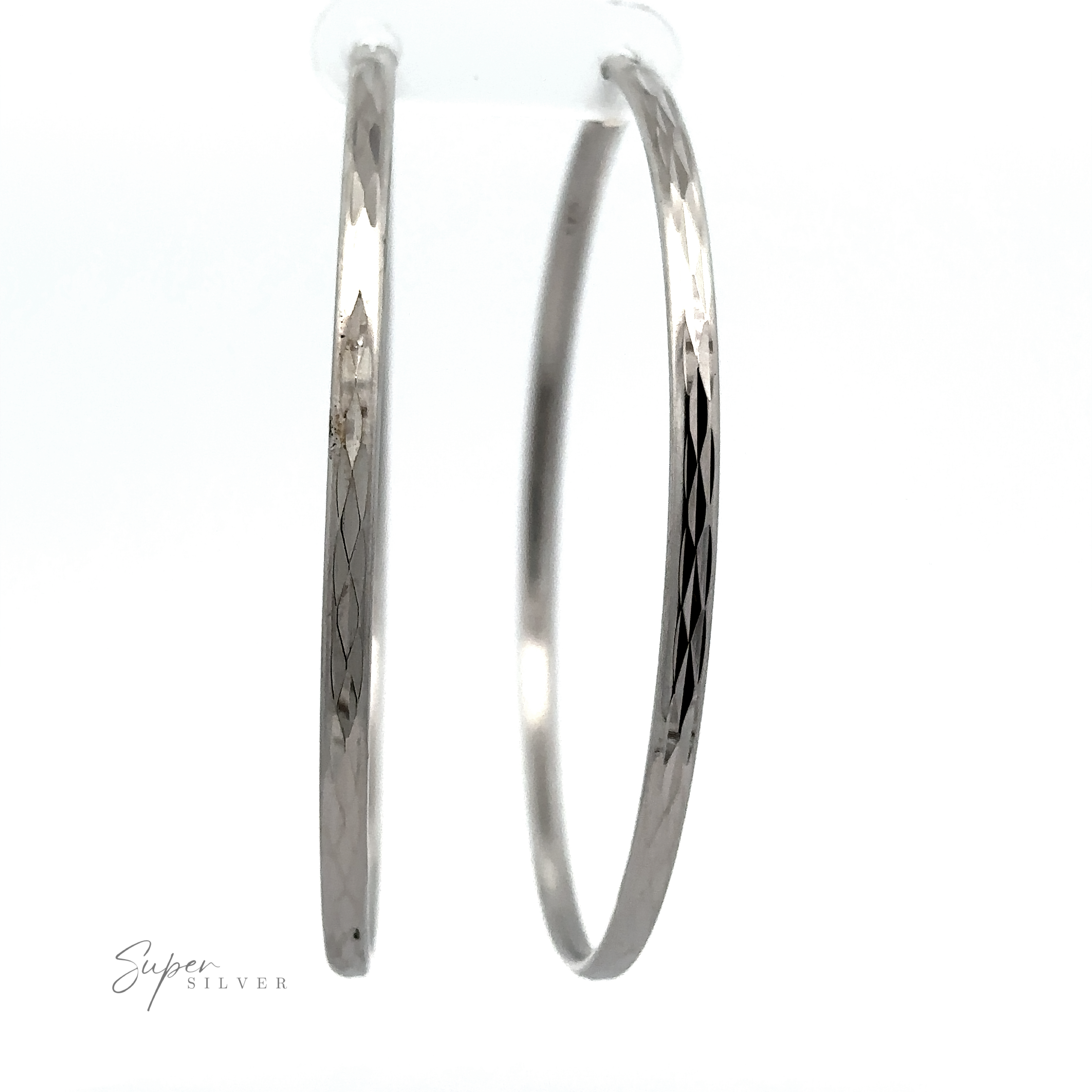 Two Flashy 60mm Diamond Faceted Hoops with etched designs, displayed against a white background with a "super silver" signature at the bottom.