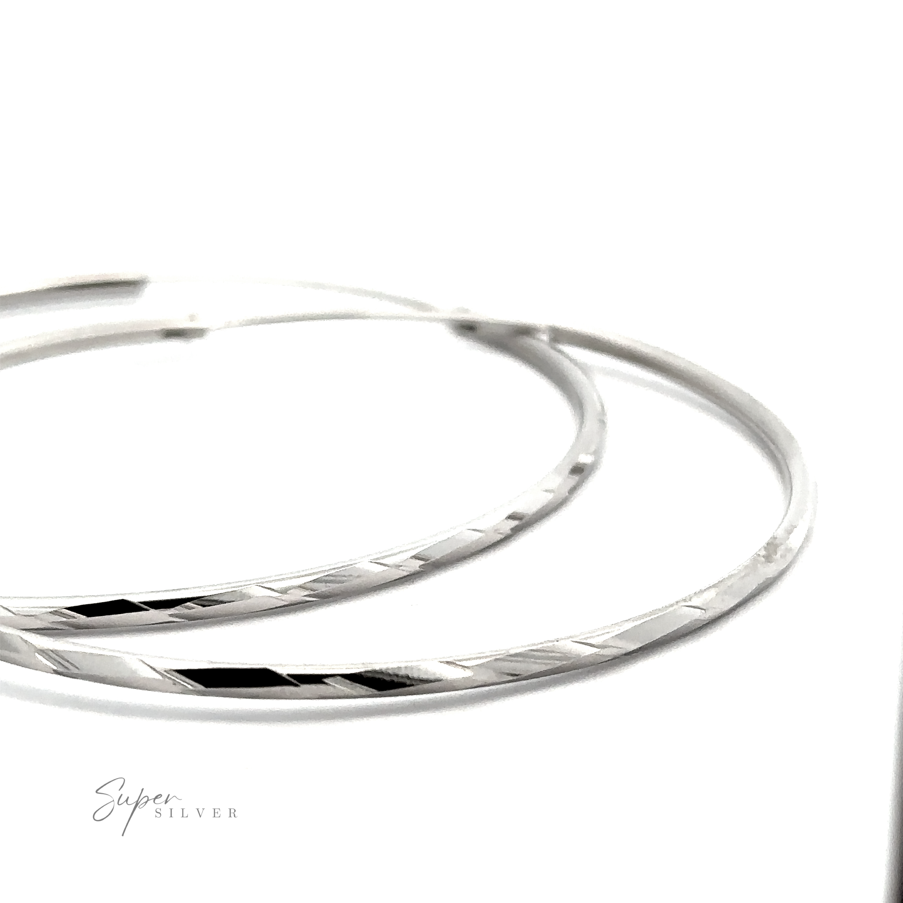 Two Brilliant 60mm Rhodium Finish Faceted Hoops with a twisted design, displayed on a white background with the text "super silver" visible.