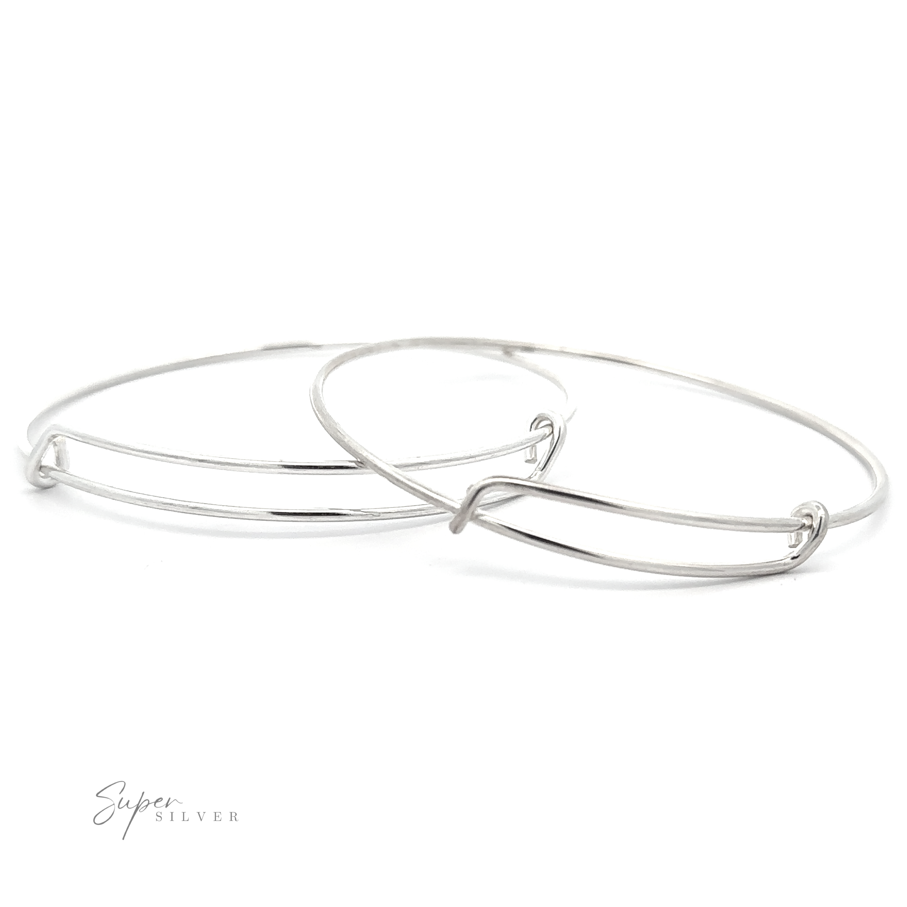 Two thin, sterling silver bangles are slightly overlapping on a white background. One bangle has a minimalist design with a subtle twist detail. The "Simple Adjustable Bangle Bracelet" logo is visible in the bottom left corner, enhancing the elegance of these exquisite pieces.