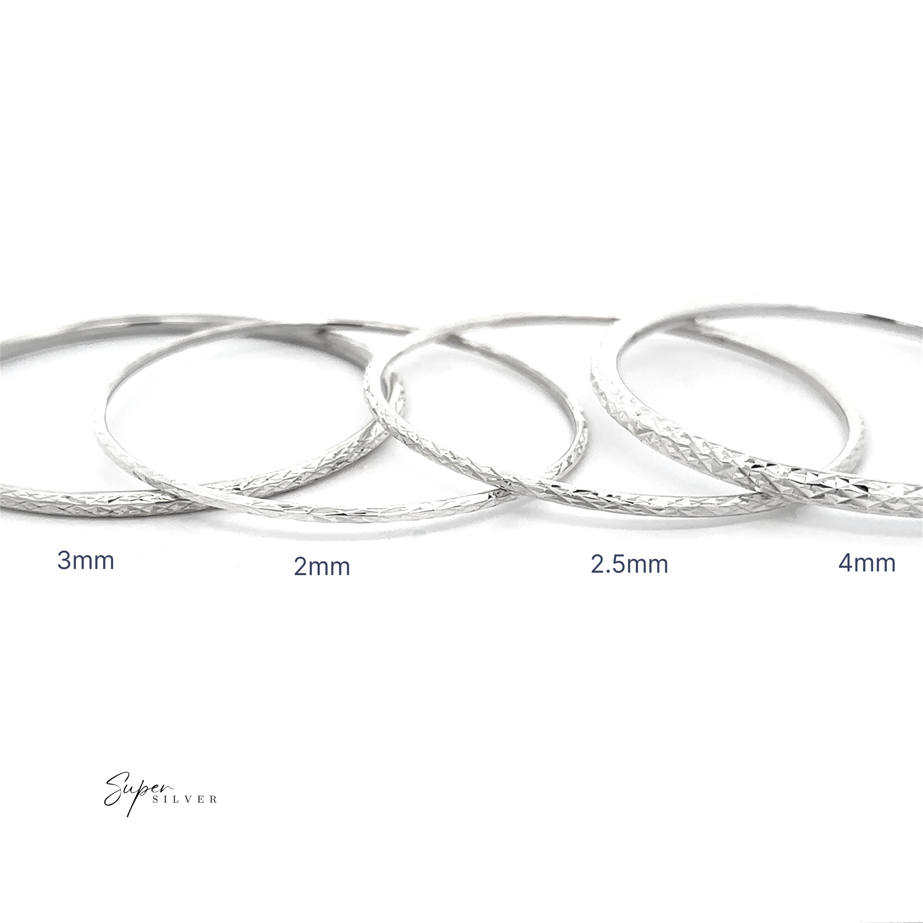 The Spark Stack Bangles—Sterling Silver in widths of 3mm, 2mm, 2.5mm, and 4mm—are artfully displayed side by side on a white background. Their refined design makes them ideal additions to any elegant jewelry collection.