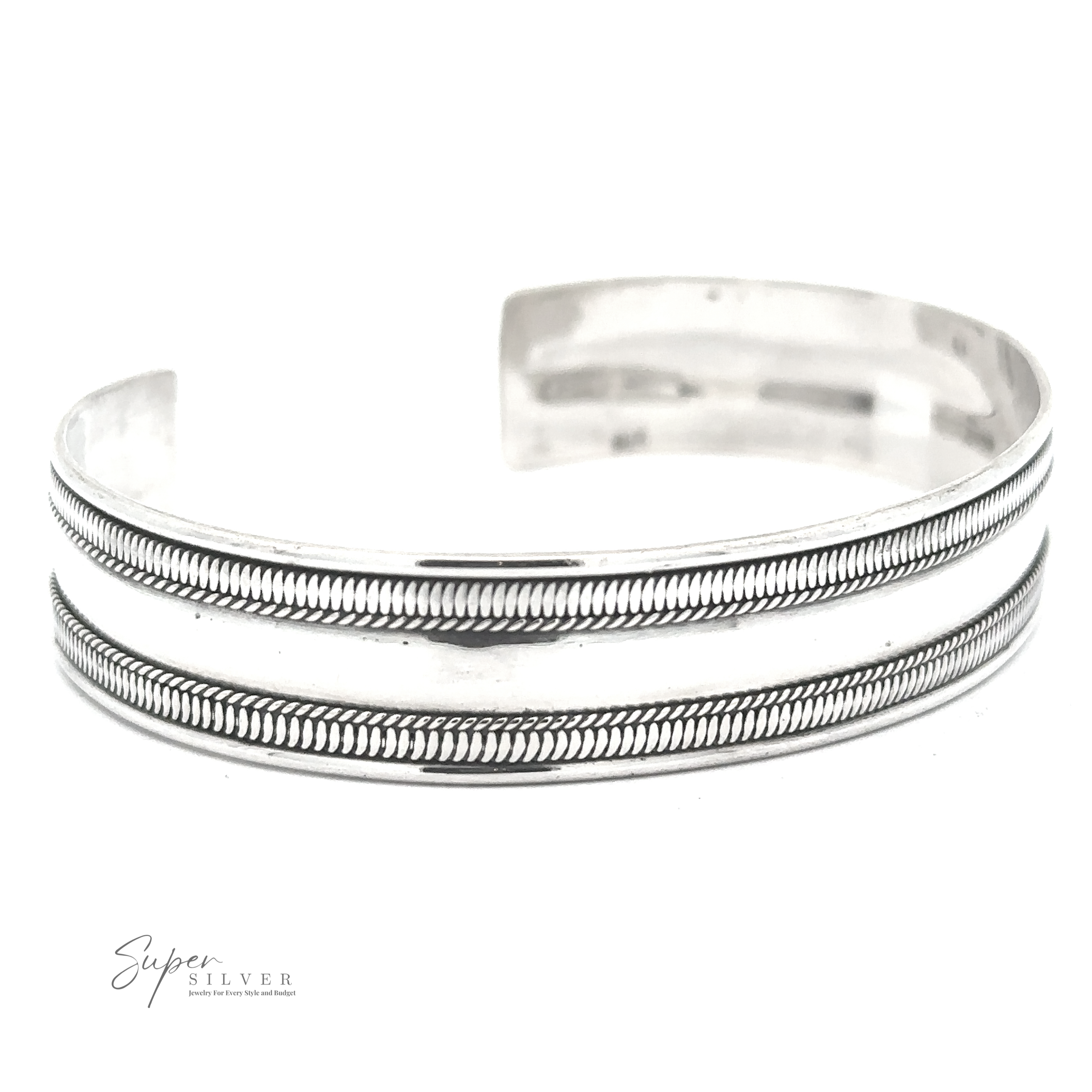 A Silver Cuff Bracelet with two parallel etched lines and a subtle pattern between them, labeled "Super Silver" in the bottom left corner. This adjustable size piece combines elegance with versatility.