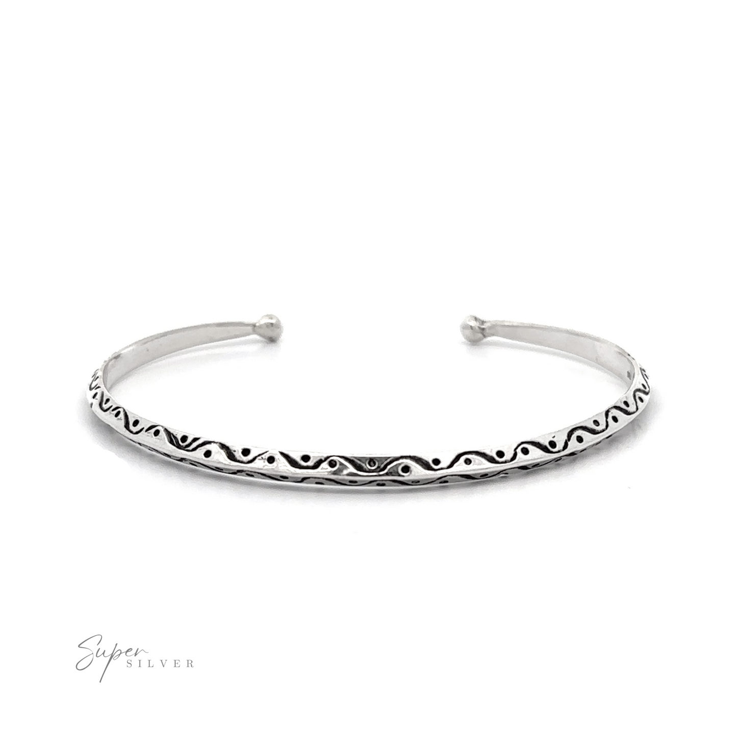 A dainty silver cuff with etching featuring a knife-edge shape.