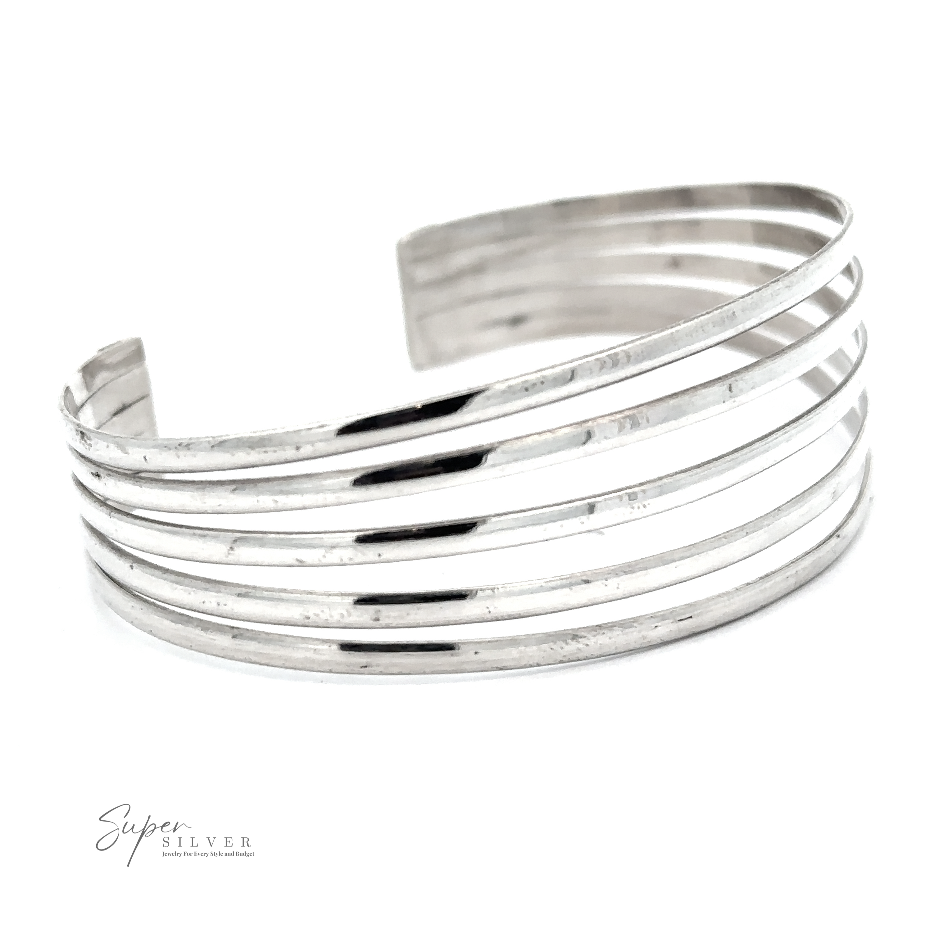 A Simple Cuff with Open Design with multiple horizontal bands, displayed on a white background. The words "Super Silver" are visible in the lower-left corner, capturing its modern chic essence.